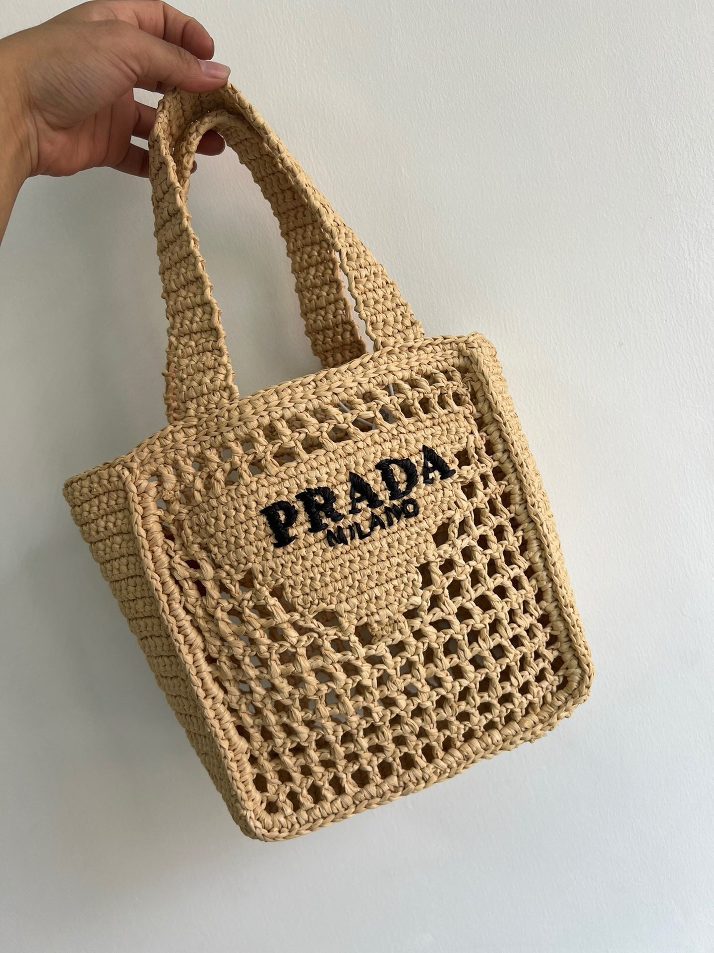 Pra*a small crochet tote in beige raffia-effect yarn