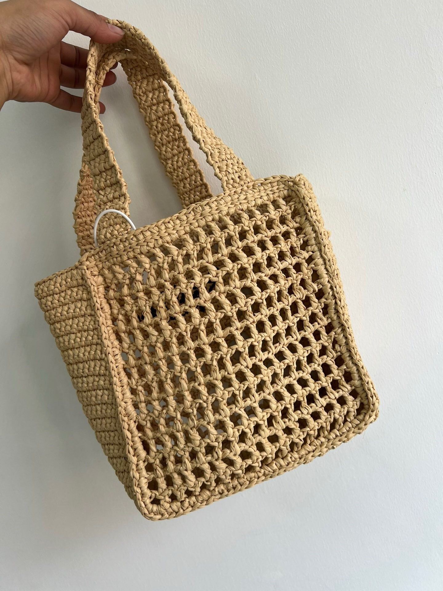 Pra*a small crochet tote in beige raffia-effect yarn