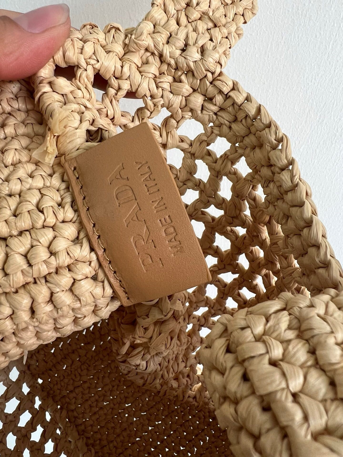 Pra*a small crochet tote in beige raffia-effect yarn