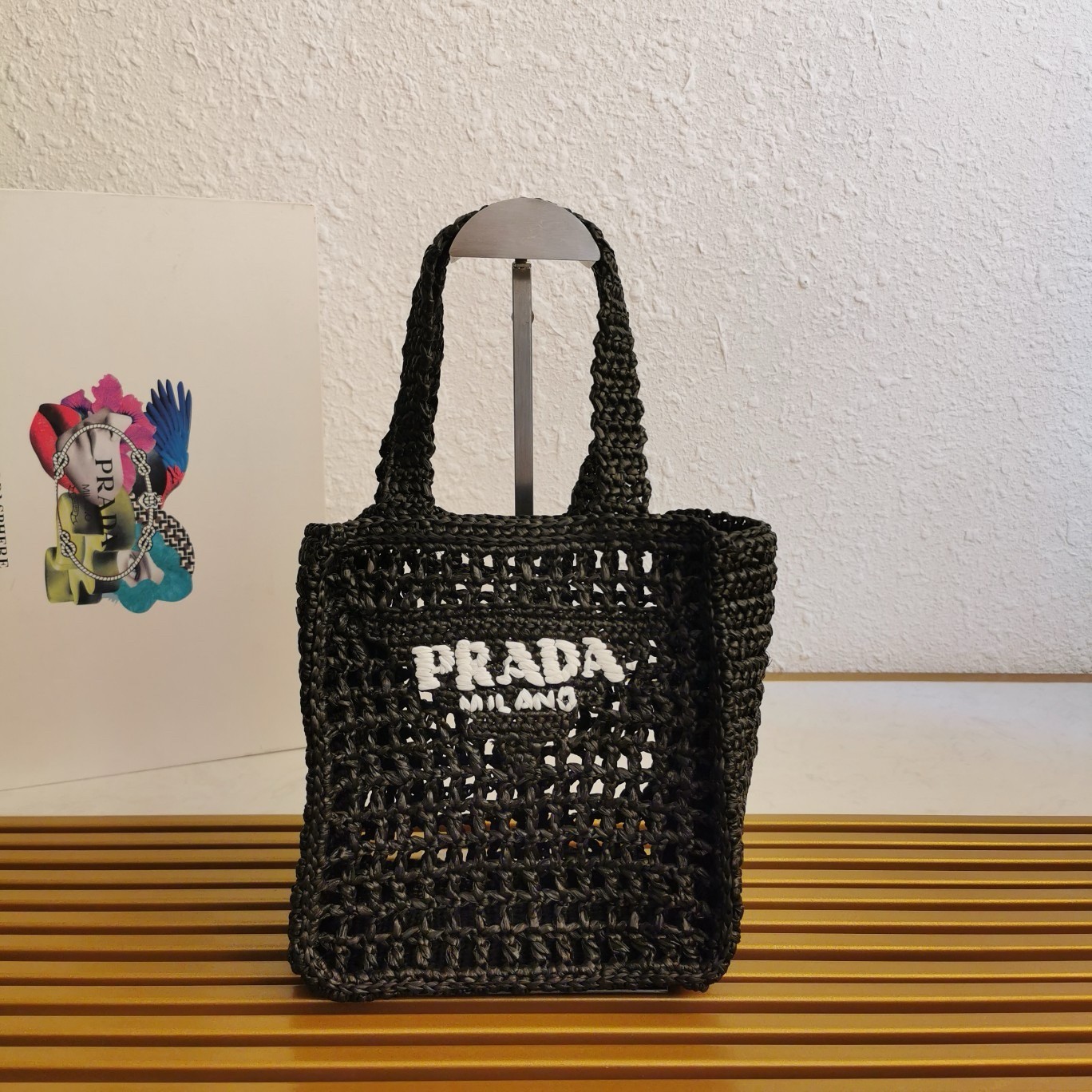 Pra*a small crochet tote in black raffia-effect yarn