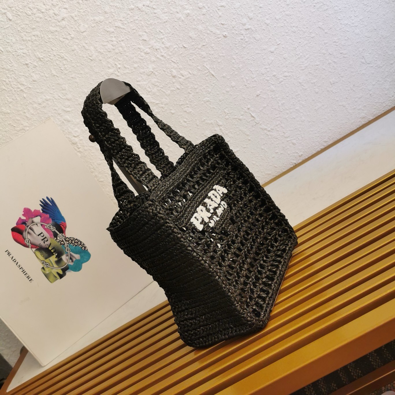Pra*a small crochet tote in black raffia-effect yarn
