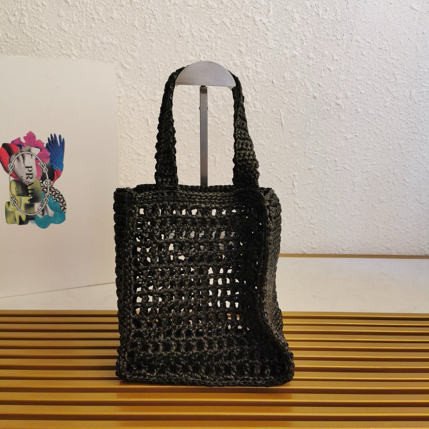Pra*a small crochet tote in black raffia-effect yarn
