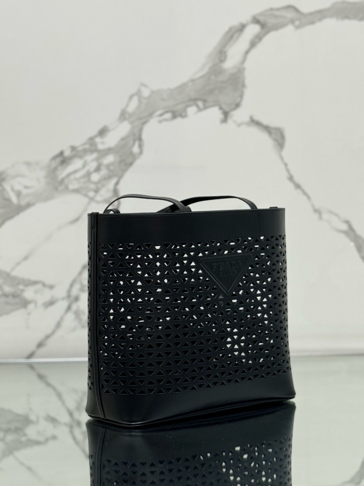 Pra*a large tote bag in black perforated leather