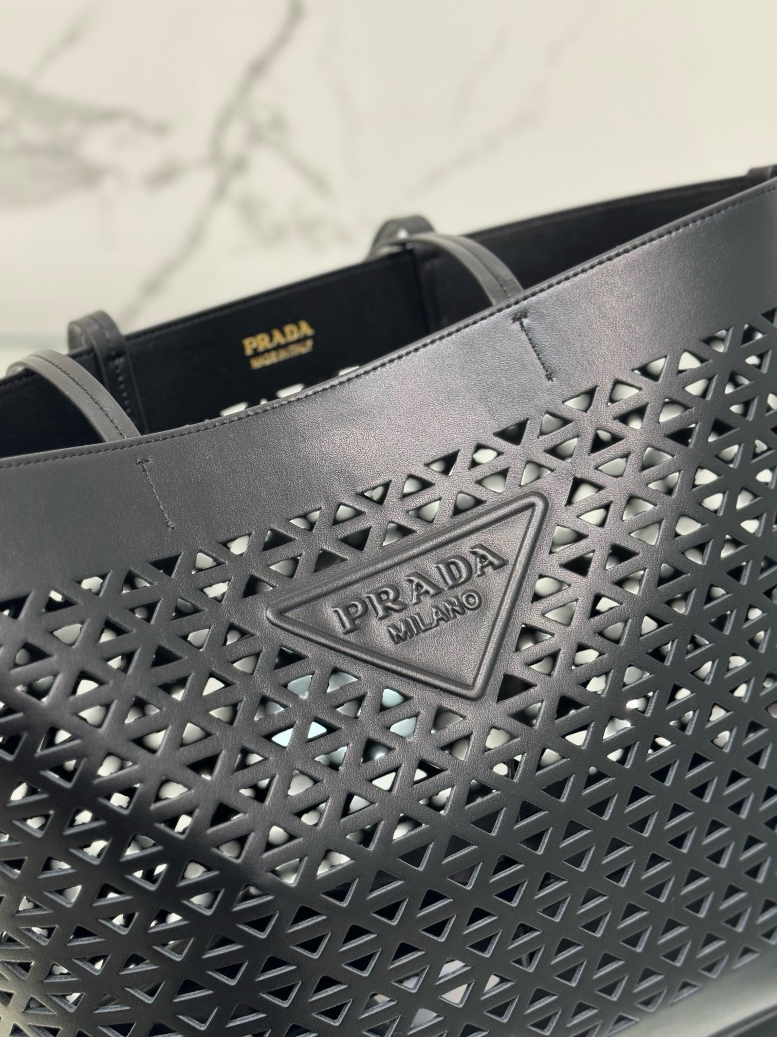 Pra*a large tote bag in black perforated leather