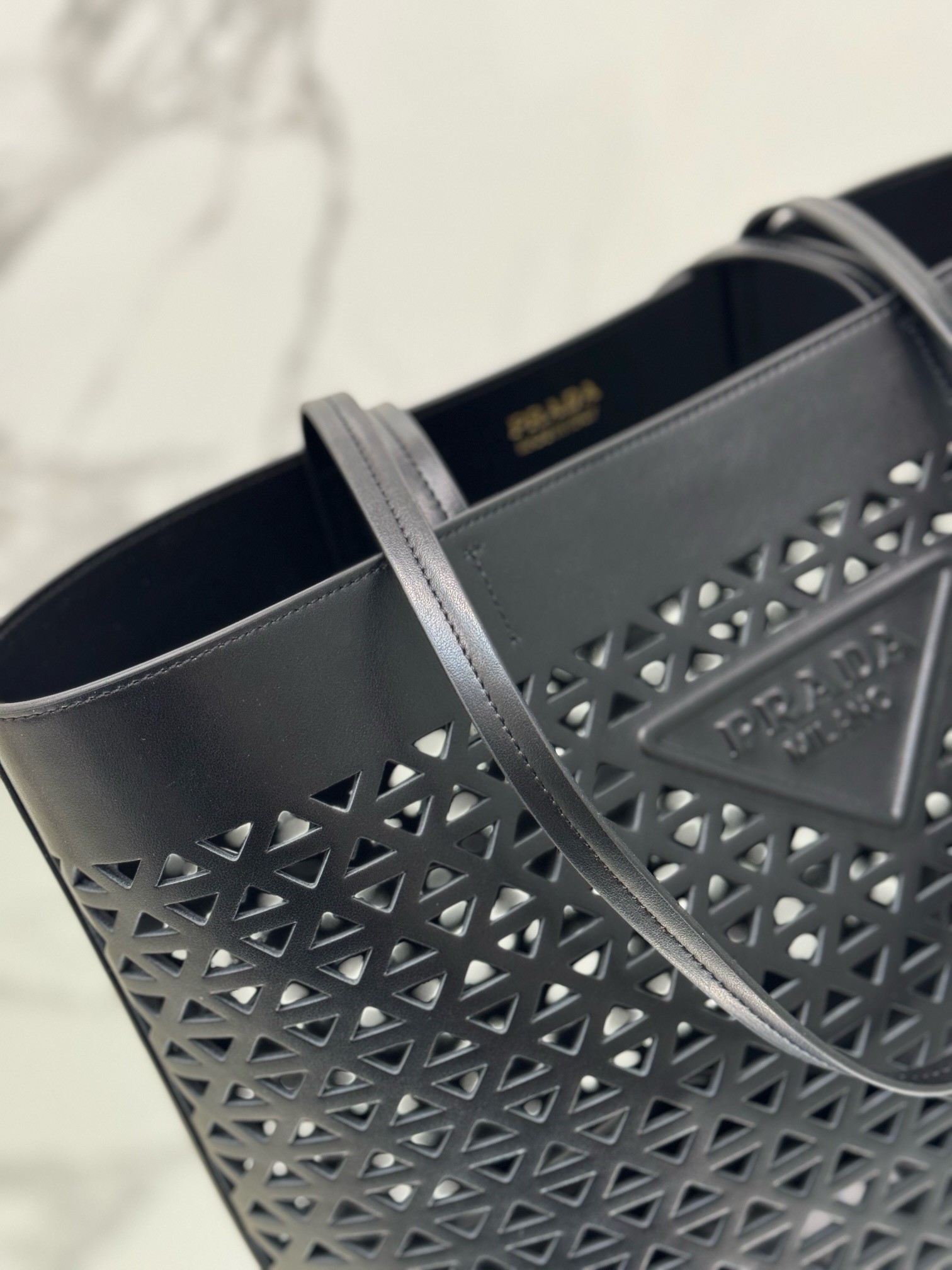 Pra*a large tote bag in black perforated leather