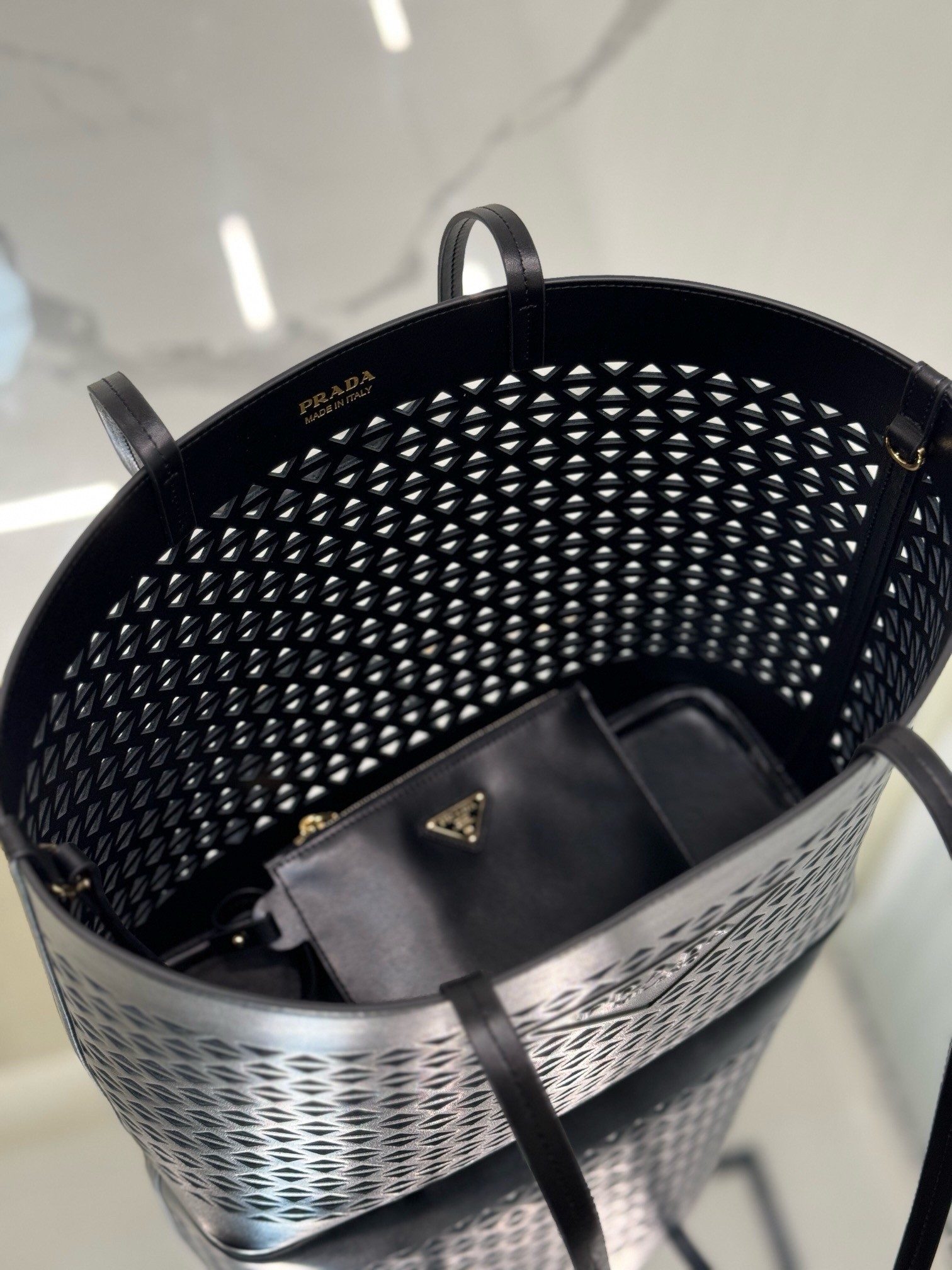 Pra*a large tote bag in black perforated leather