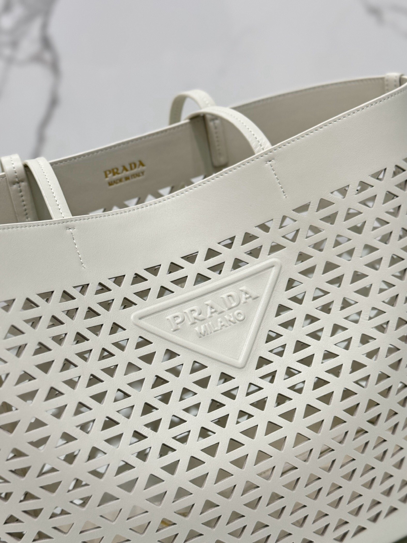 Pra*a large tote bag in white perforated leather