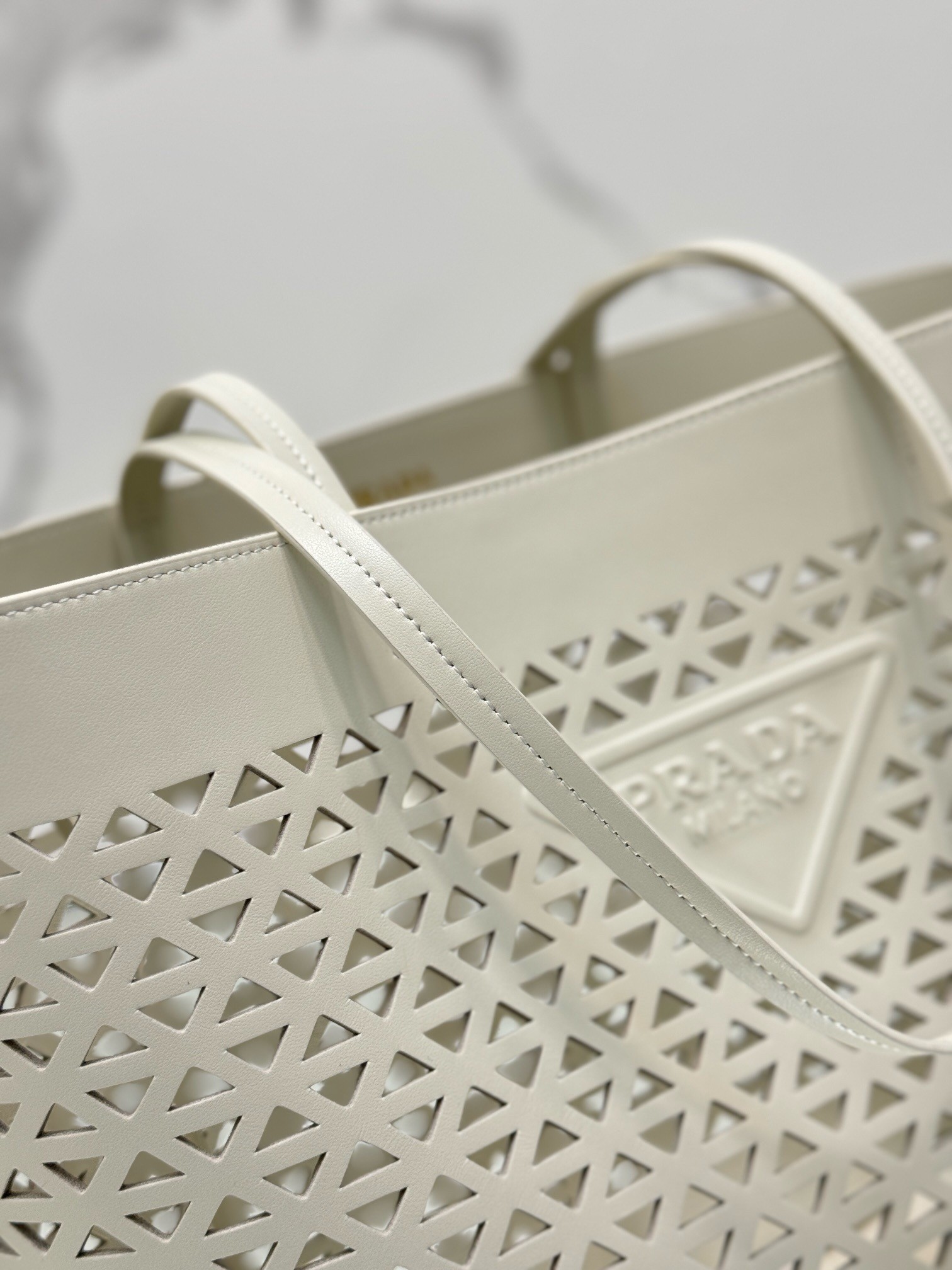 Pra*a large tote bag in white perforated leather