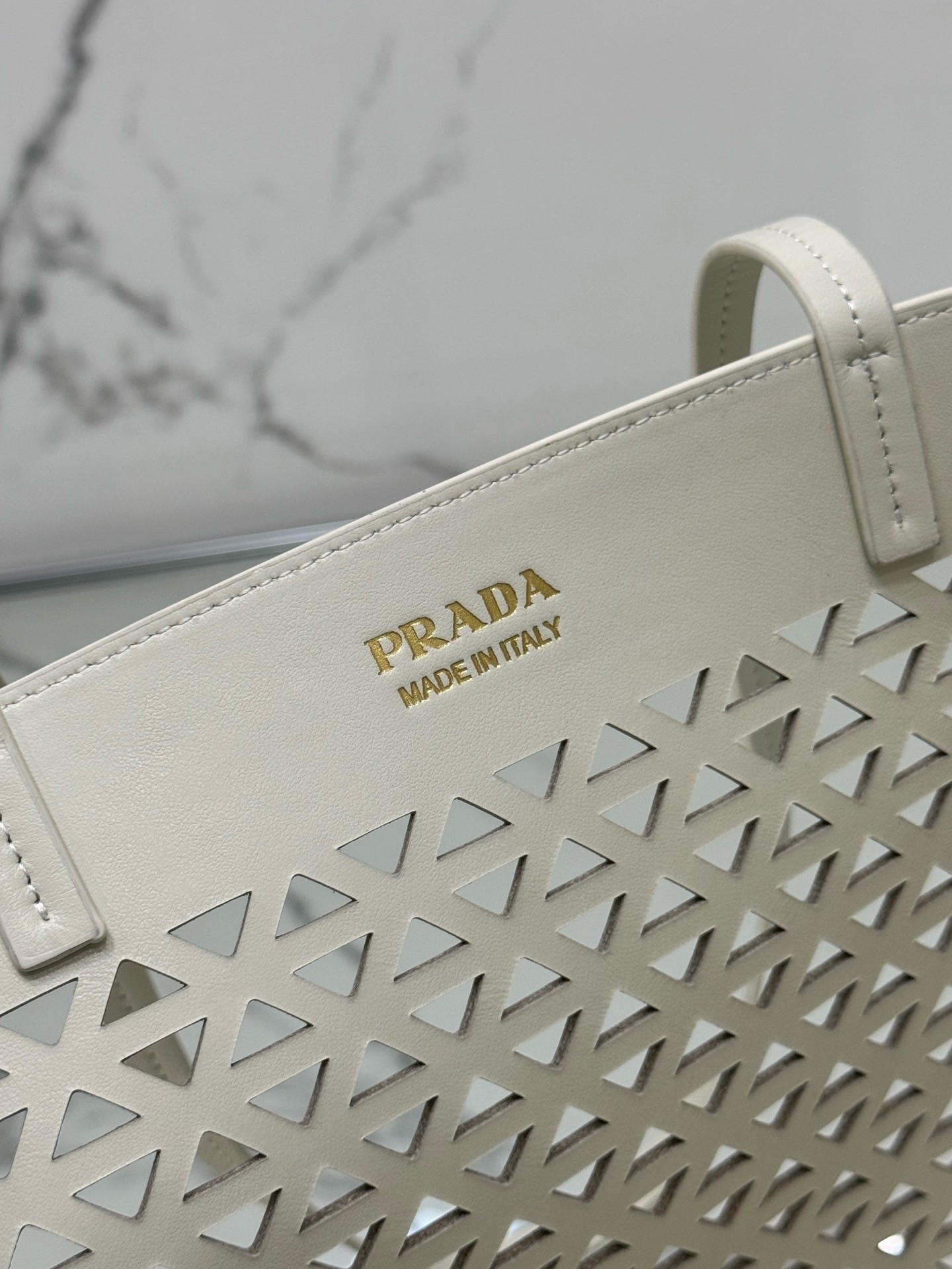 Pra*a large tote bag in white perforated leather