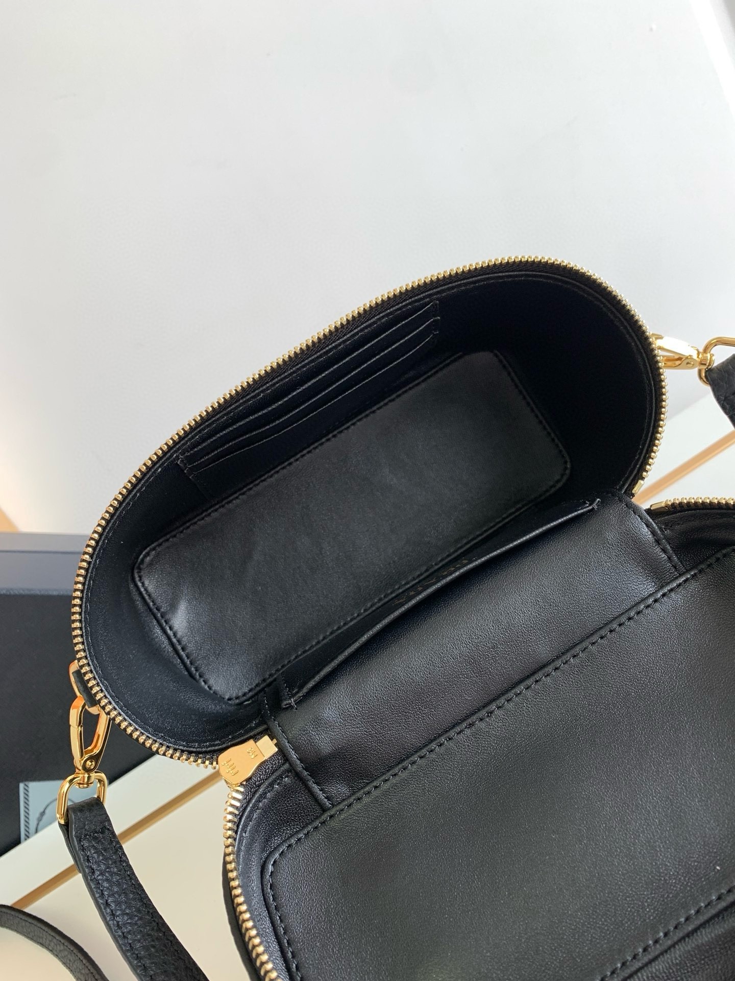 Pra*a mini vanity bag in black grained leather
