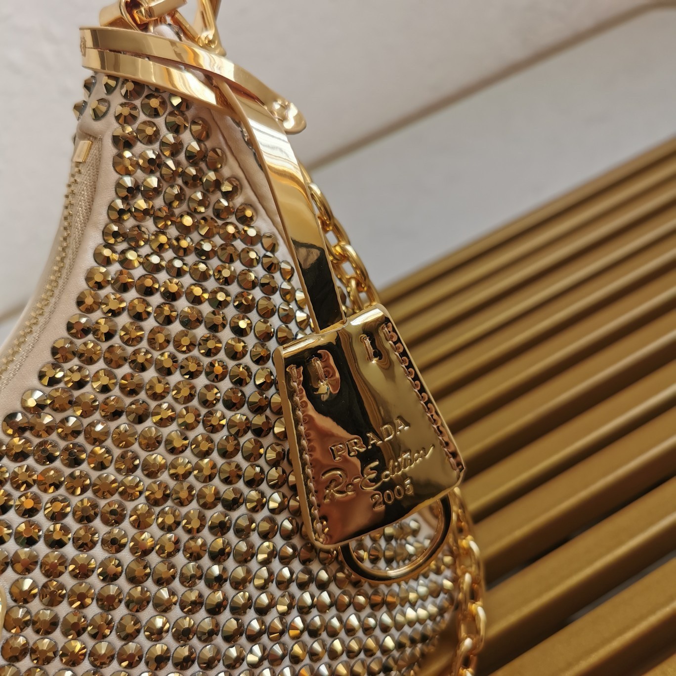 Pra*a re-edition 2005 bag in gold satin with crystal