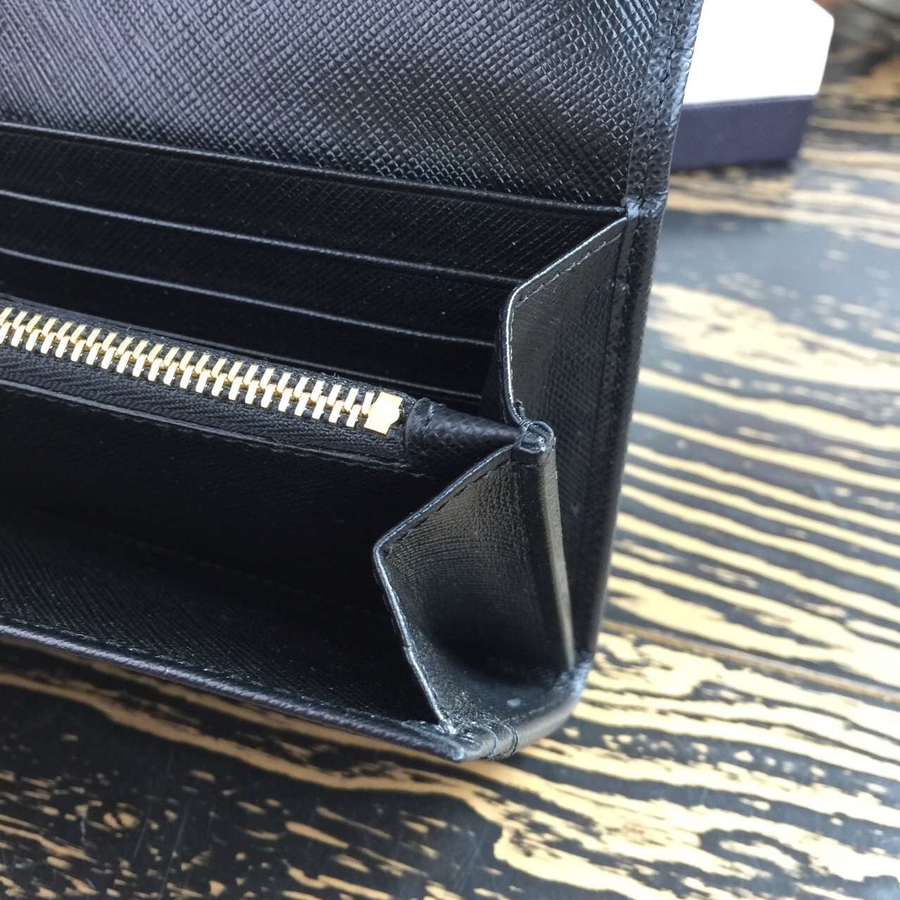 Pra*a continental wallet in black saffiano leather