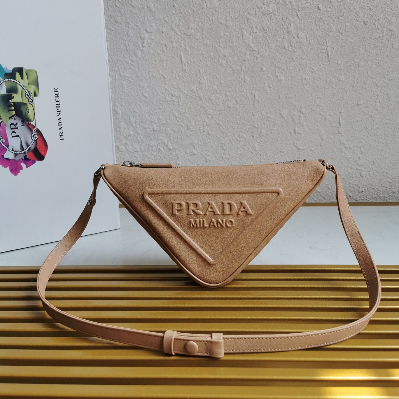 Pra*a triangle pouch bag in beige leather