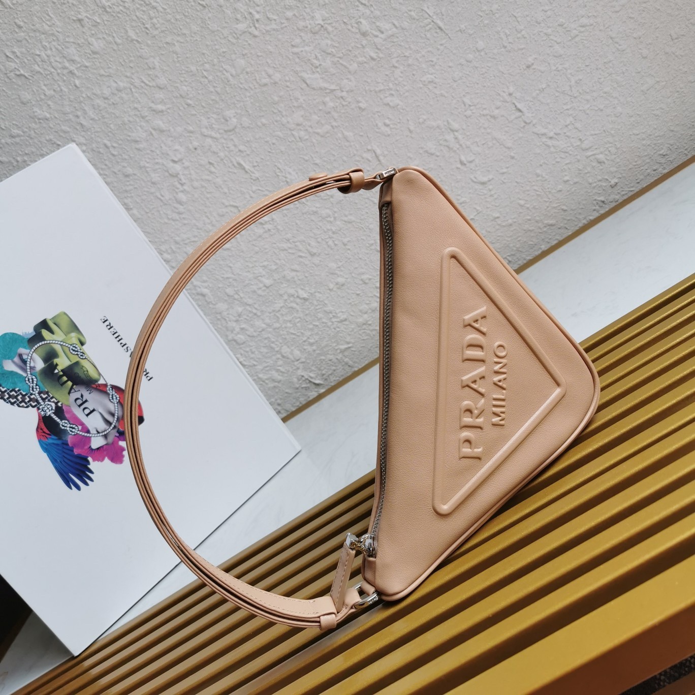 Pra*a triangle pouch bag in beige leather