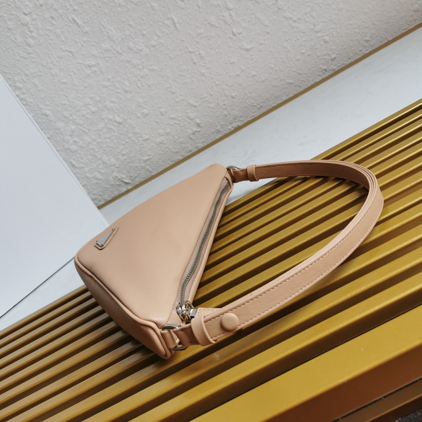 Pra*a triangle pouch bag in beige leather