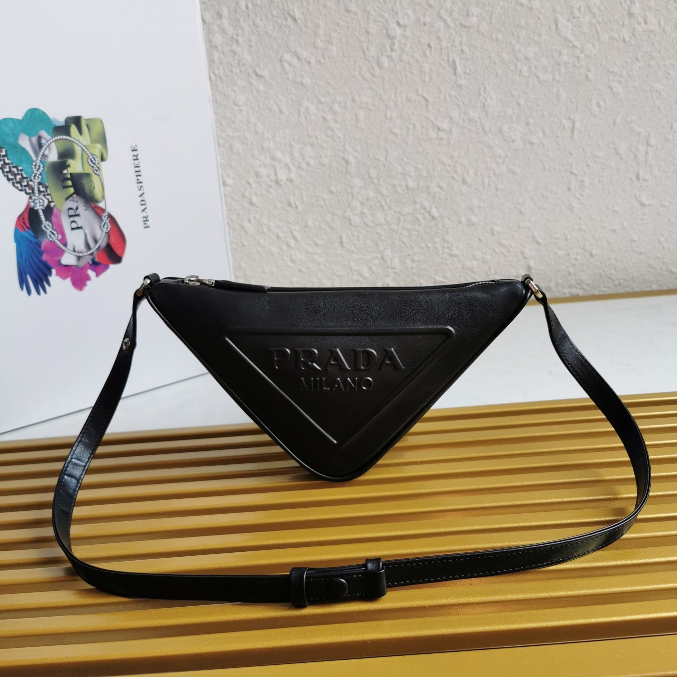 Pra*a triangle pouch bag in black leather