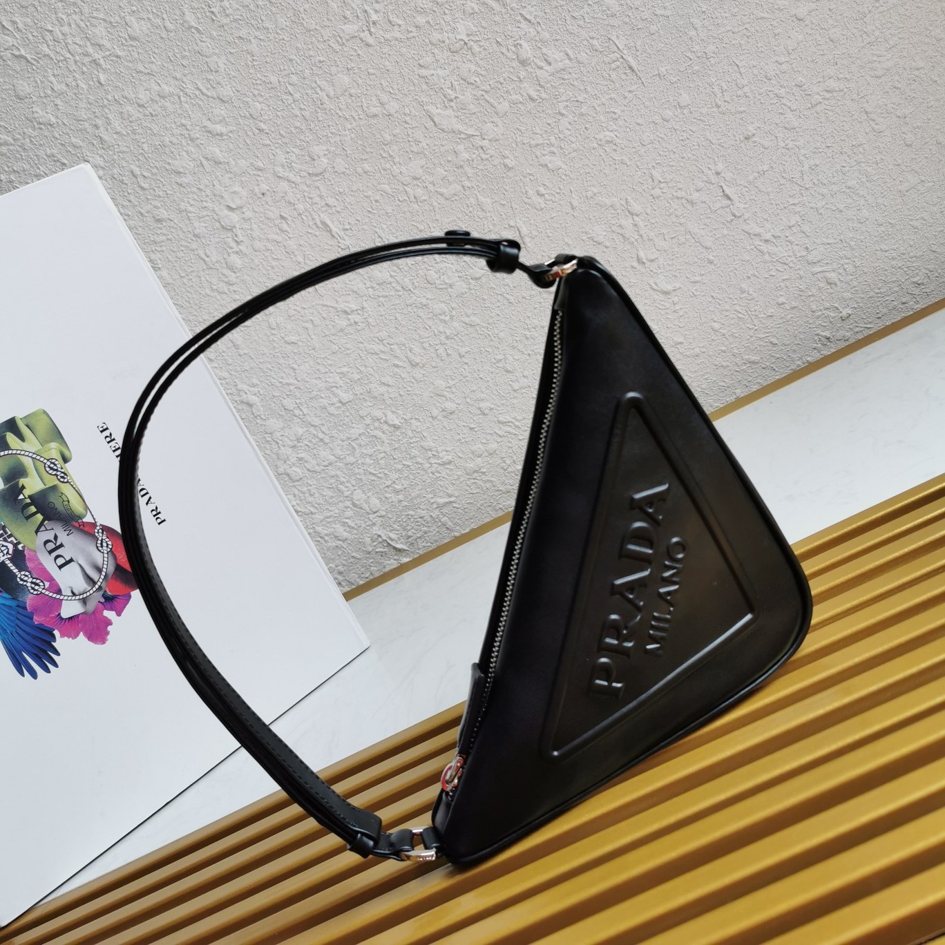 Pra*a triangle pouch bag in black leather
