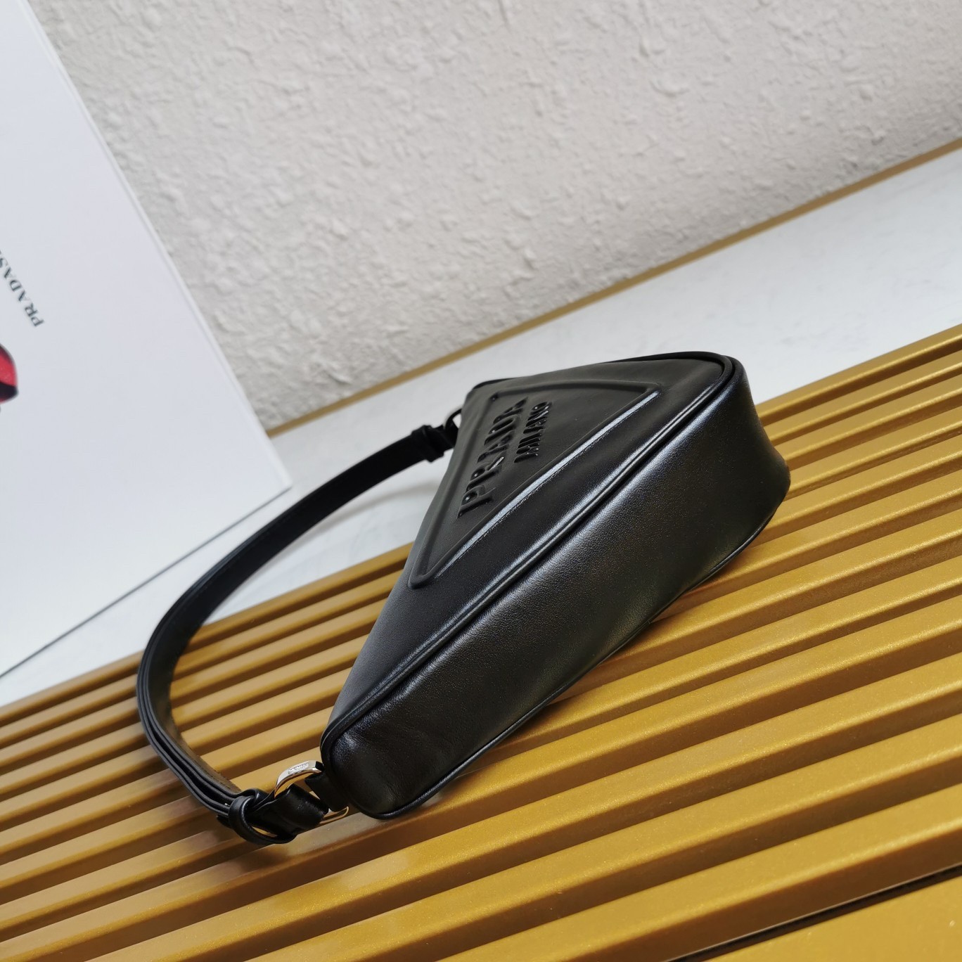Pra*a triangle pouch bag in black leather