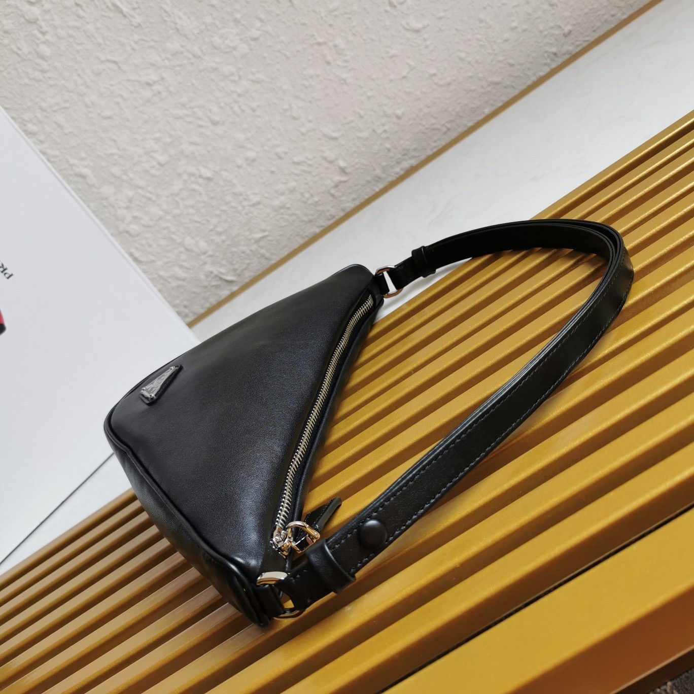 Pra*a triangle pouch bag in black leather