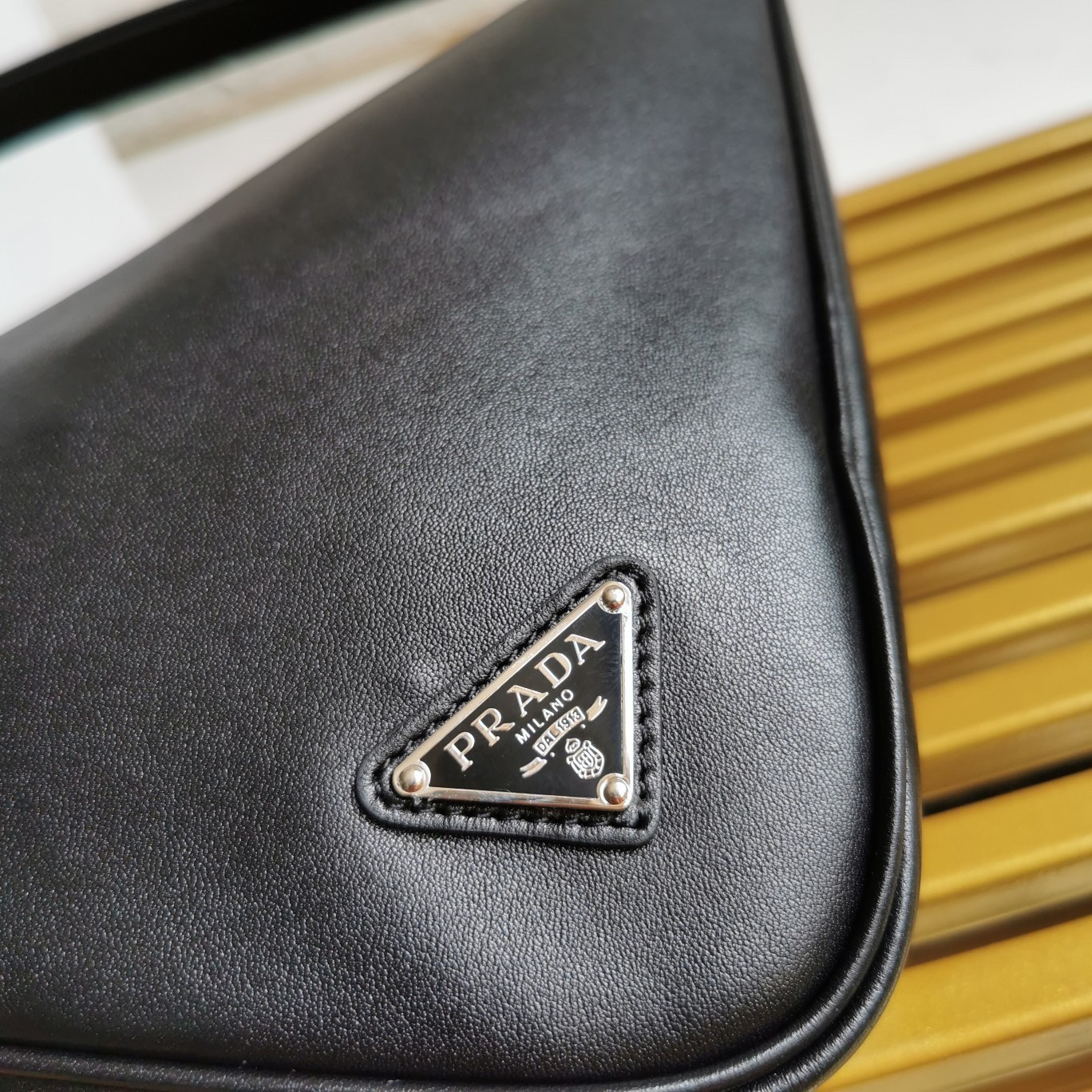 Pra*a triangle pouch bag in black leather