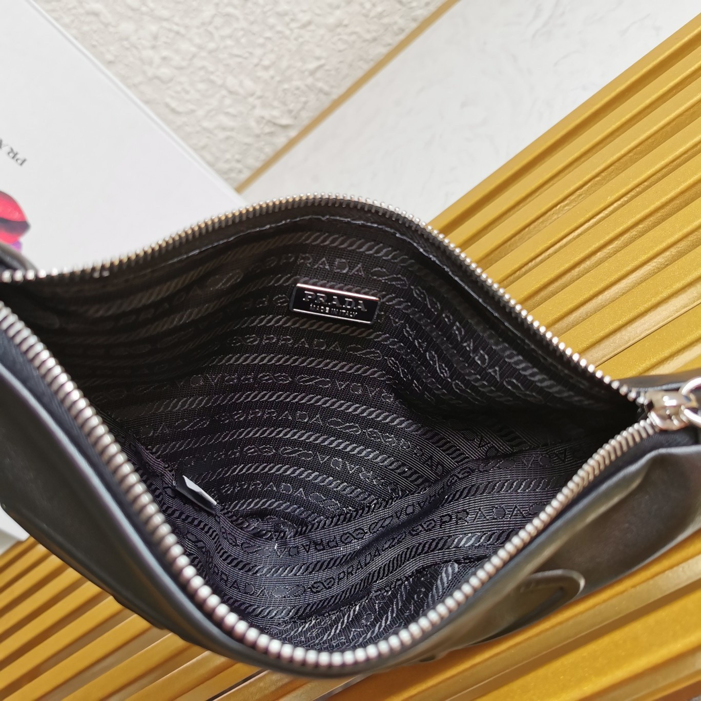 Pra*a triangle pouch bag in black leather