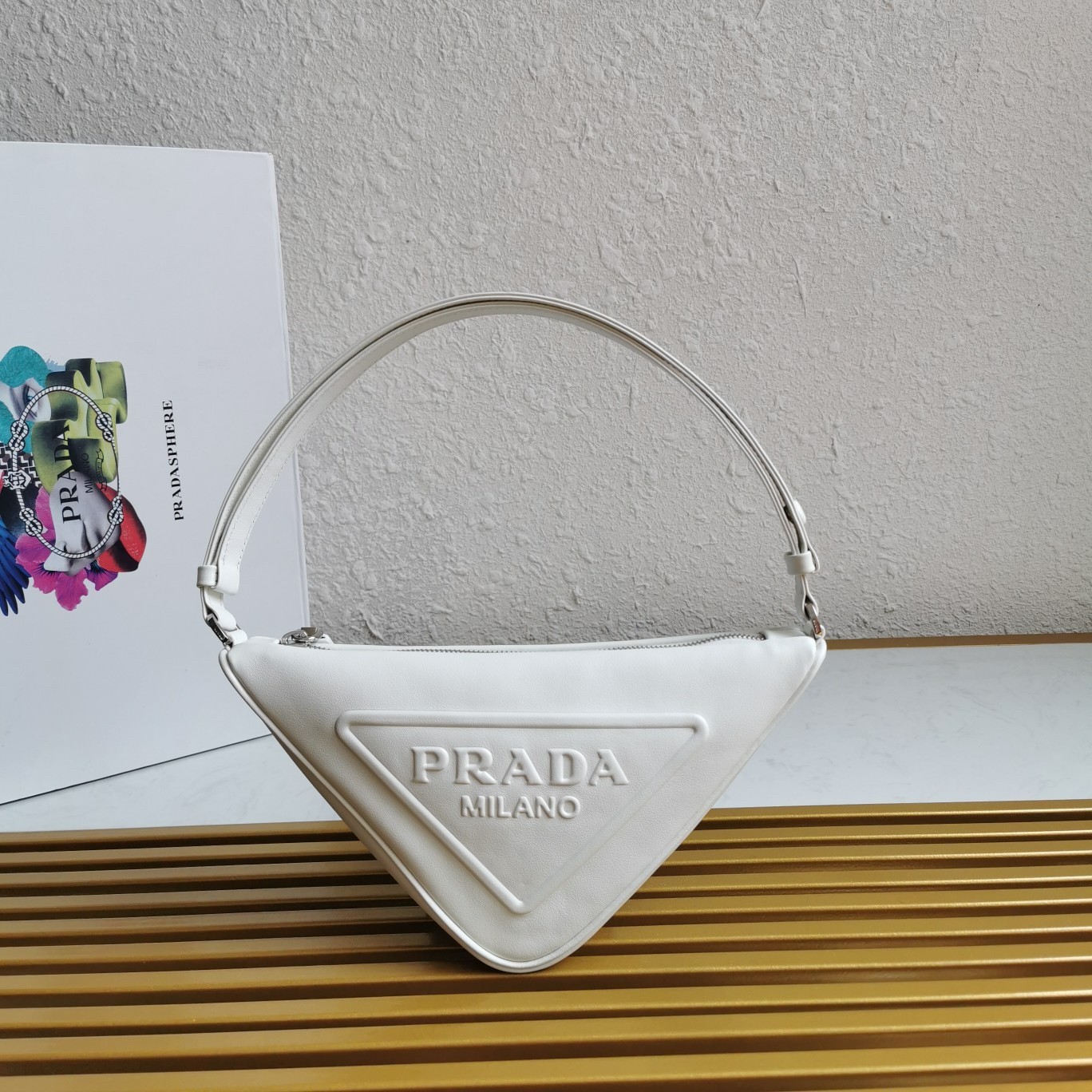 Pra*a triangle pouch bag in white leather