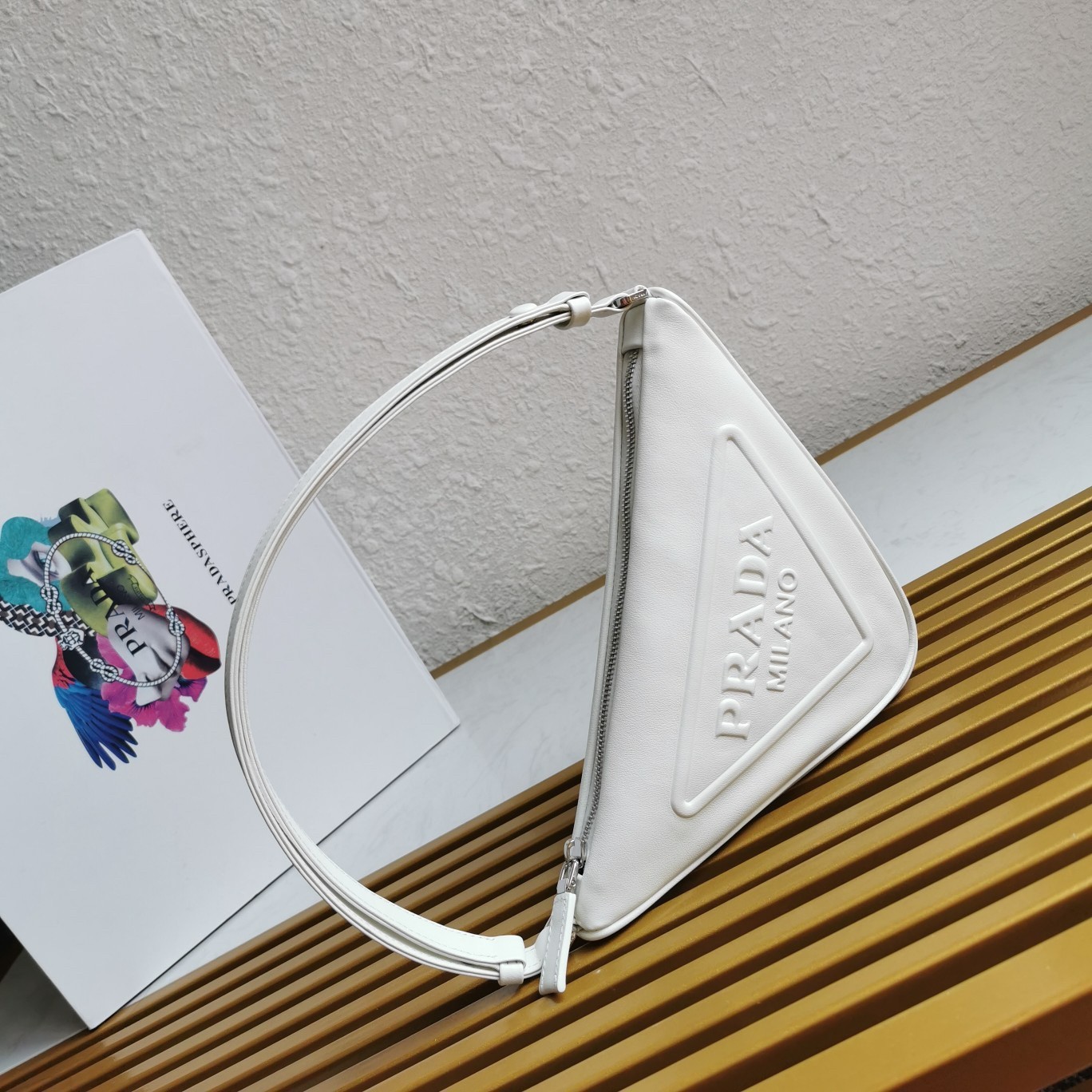 Pra*a triangle pouch bag in white leather