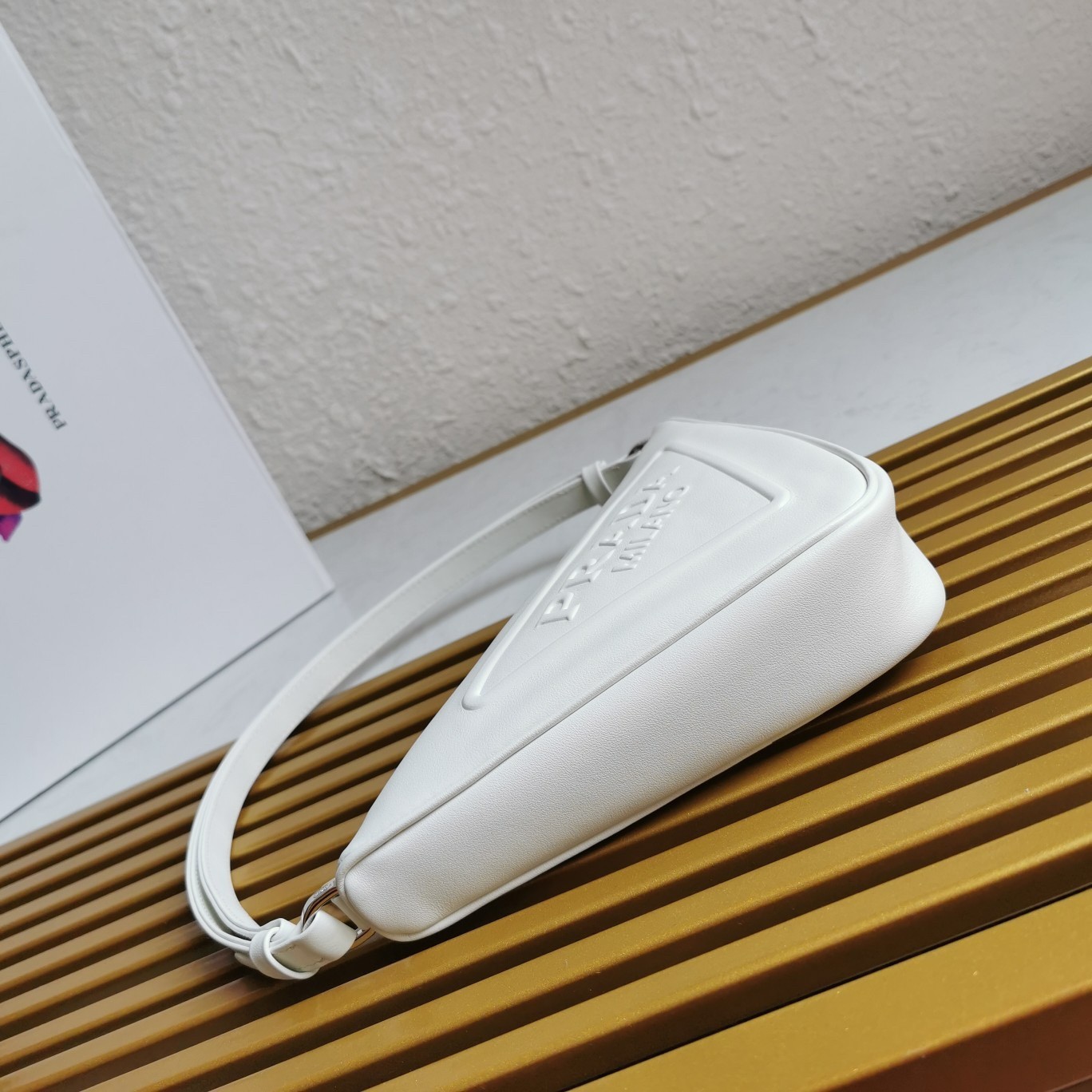 Pra*a triangle pouch bag in white leather