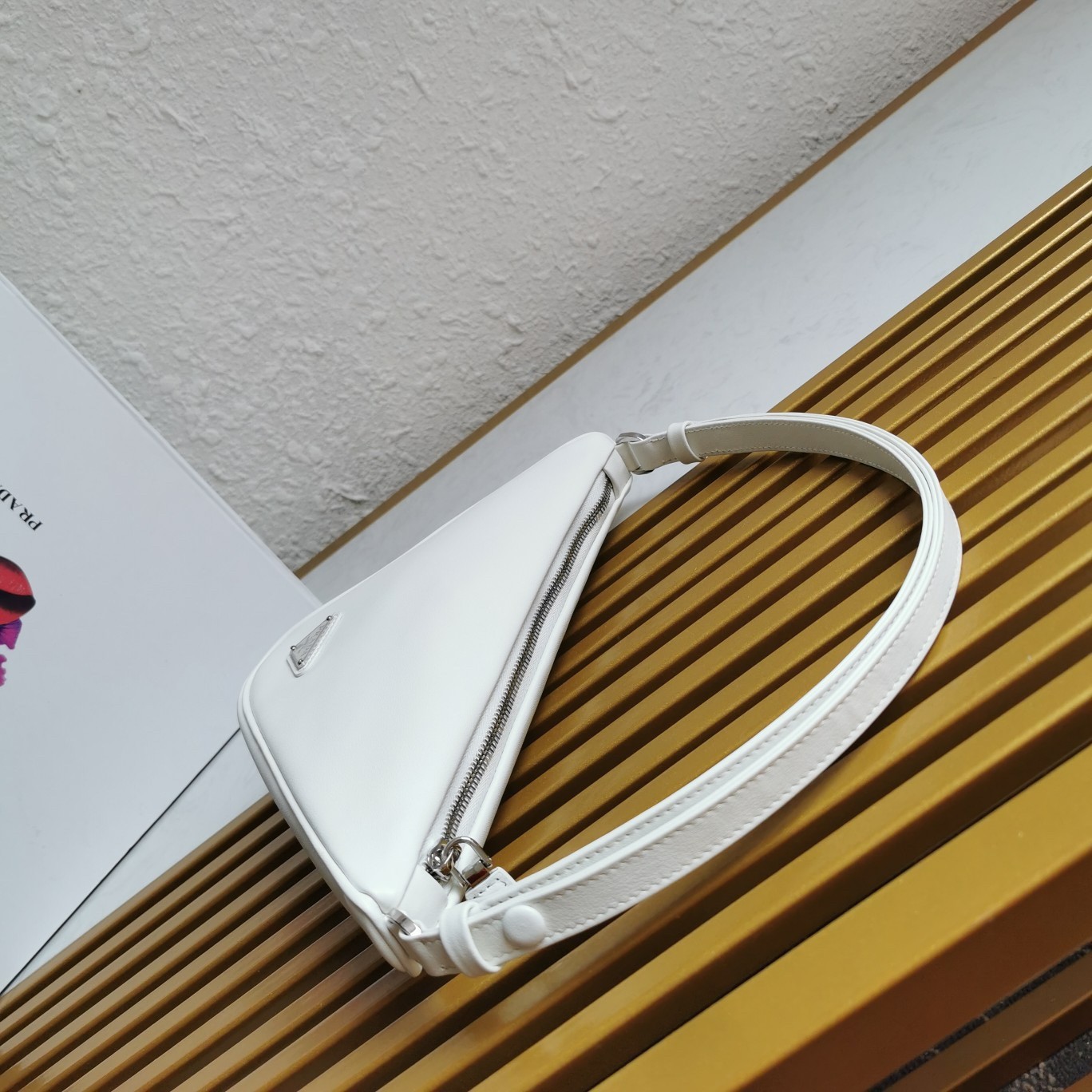 Pra*a triangle pouch bag in white leather