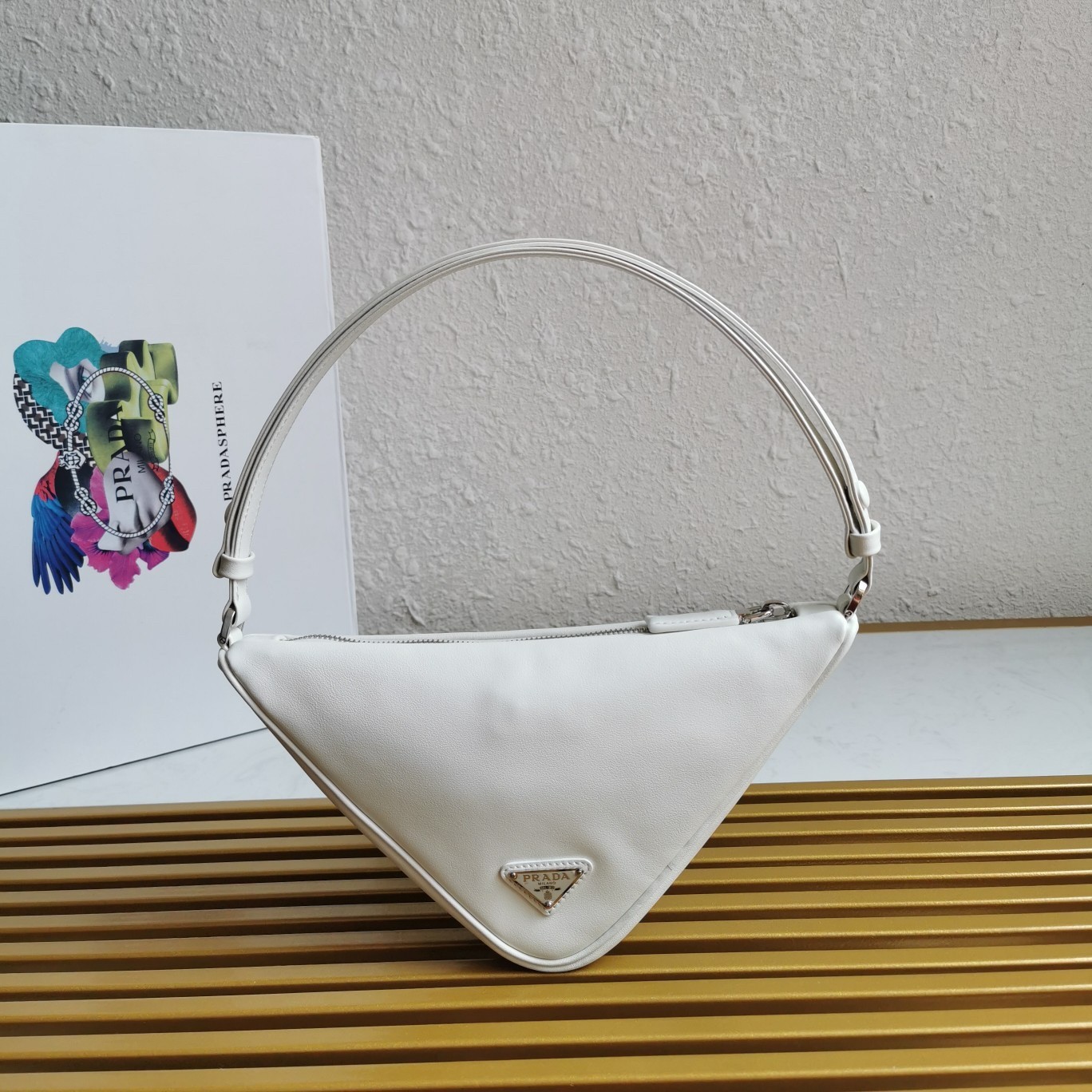 Pra*a triangle pouch bag in white leather