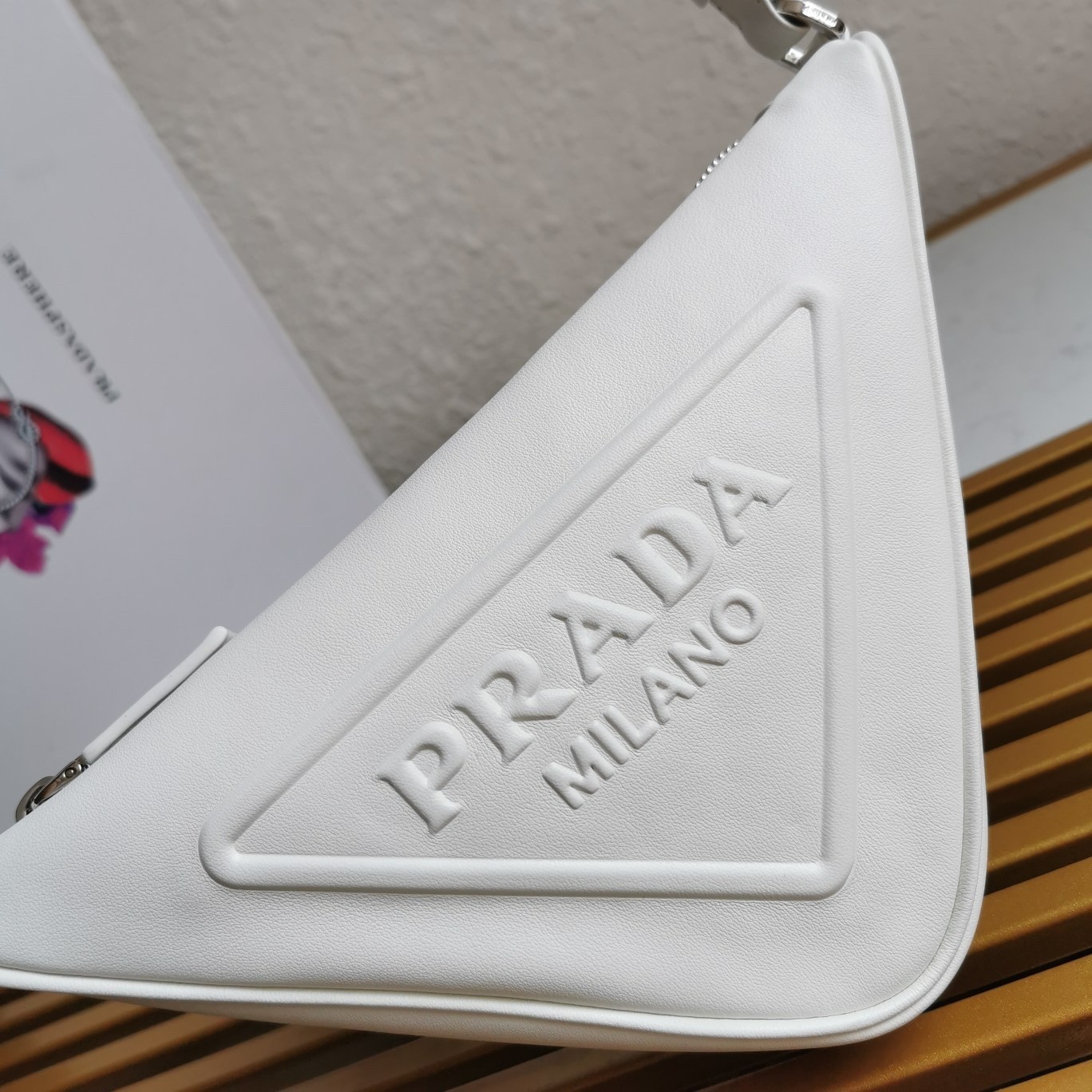 Pra*a triangle pouch bag in white leather