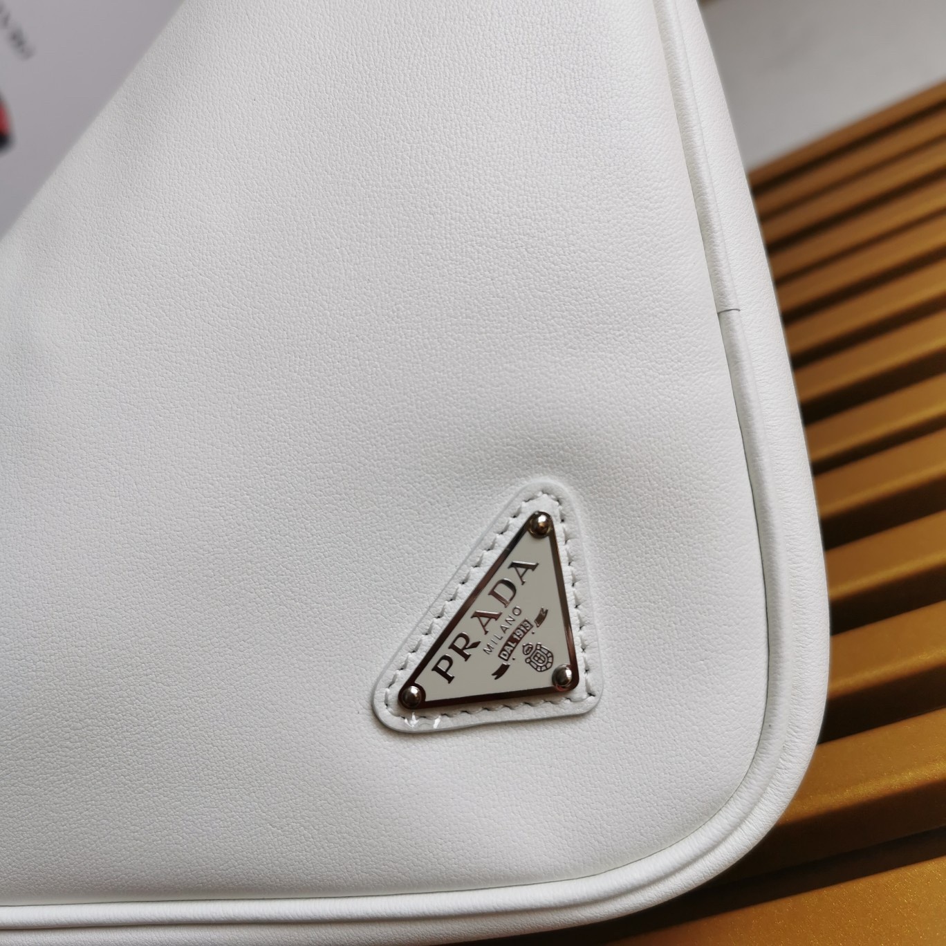 Pra*a triangle pouch bag in white leather