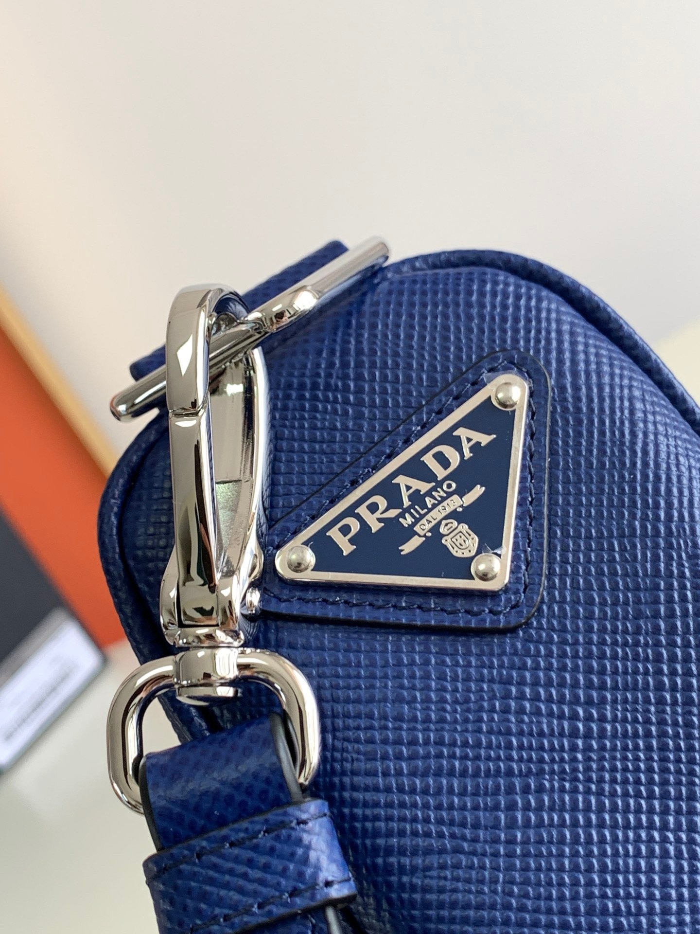 Pra*a triangle shoulder bag in blue saffiano calfskin
