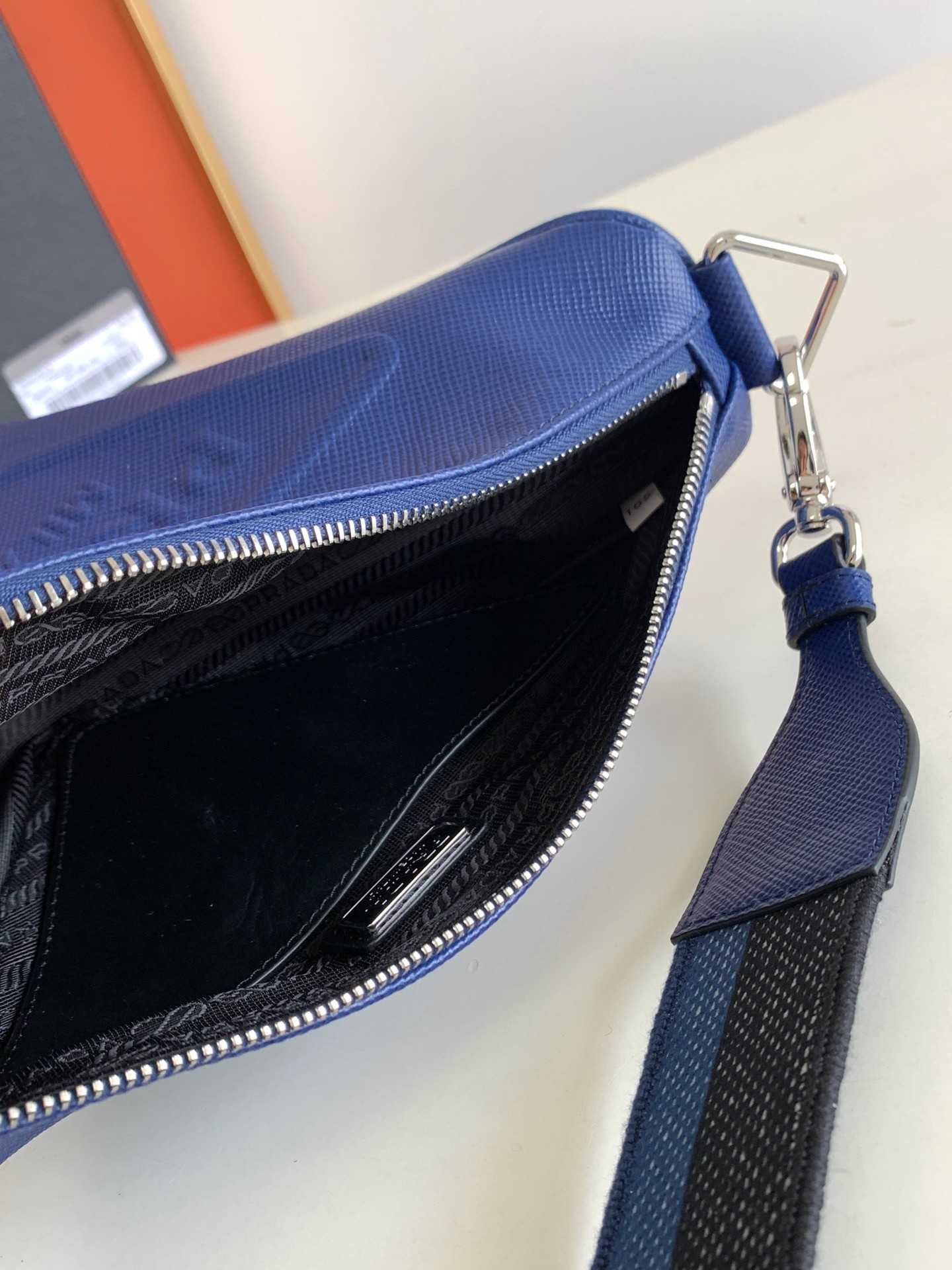Pra*a triangle shoulder bag in blue saffiano calfskin