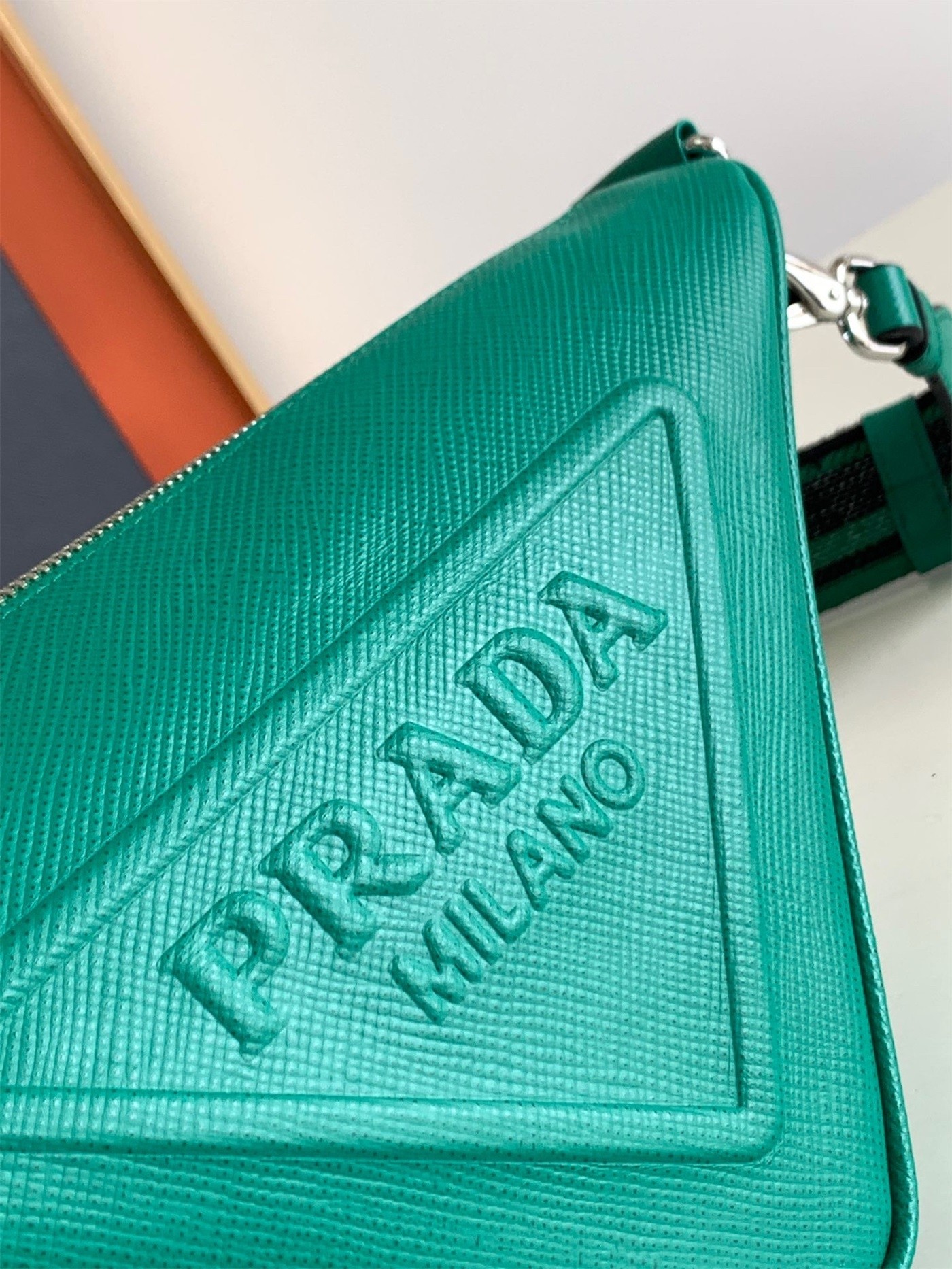 Pra*a triangle shoulder bag in green saffiano calfskin
