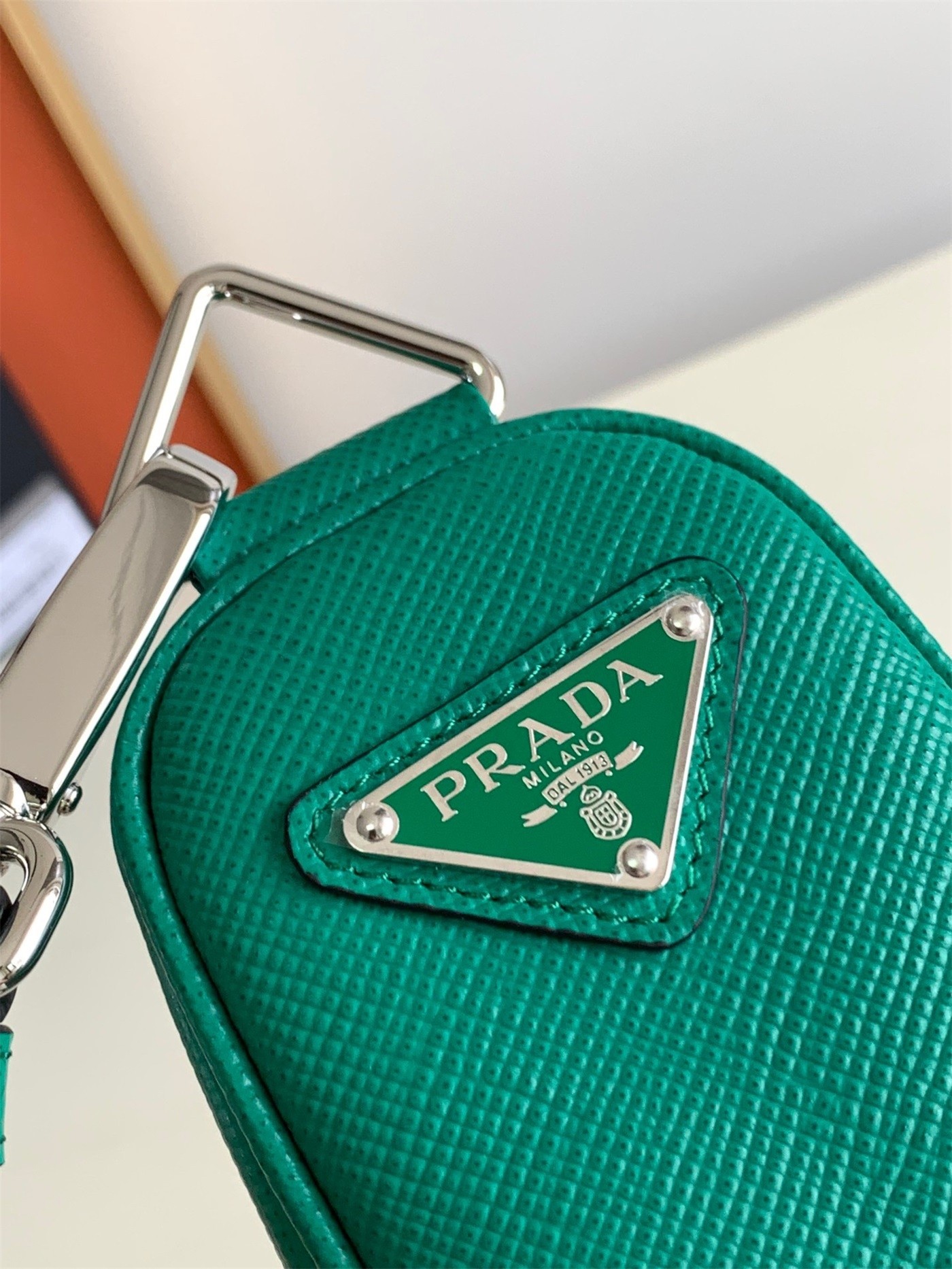 Pra*a triangle shoulder bag in green saffiano calfskin