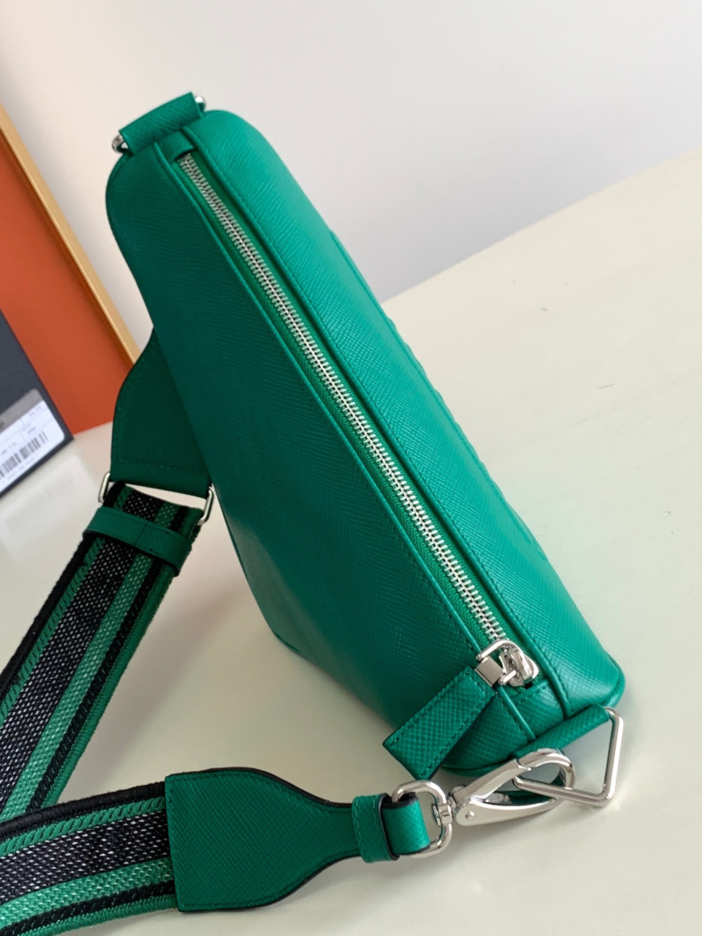 Pra*a triangle shoulder bag in green saffiano calfskin