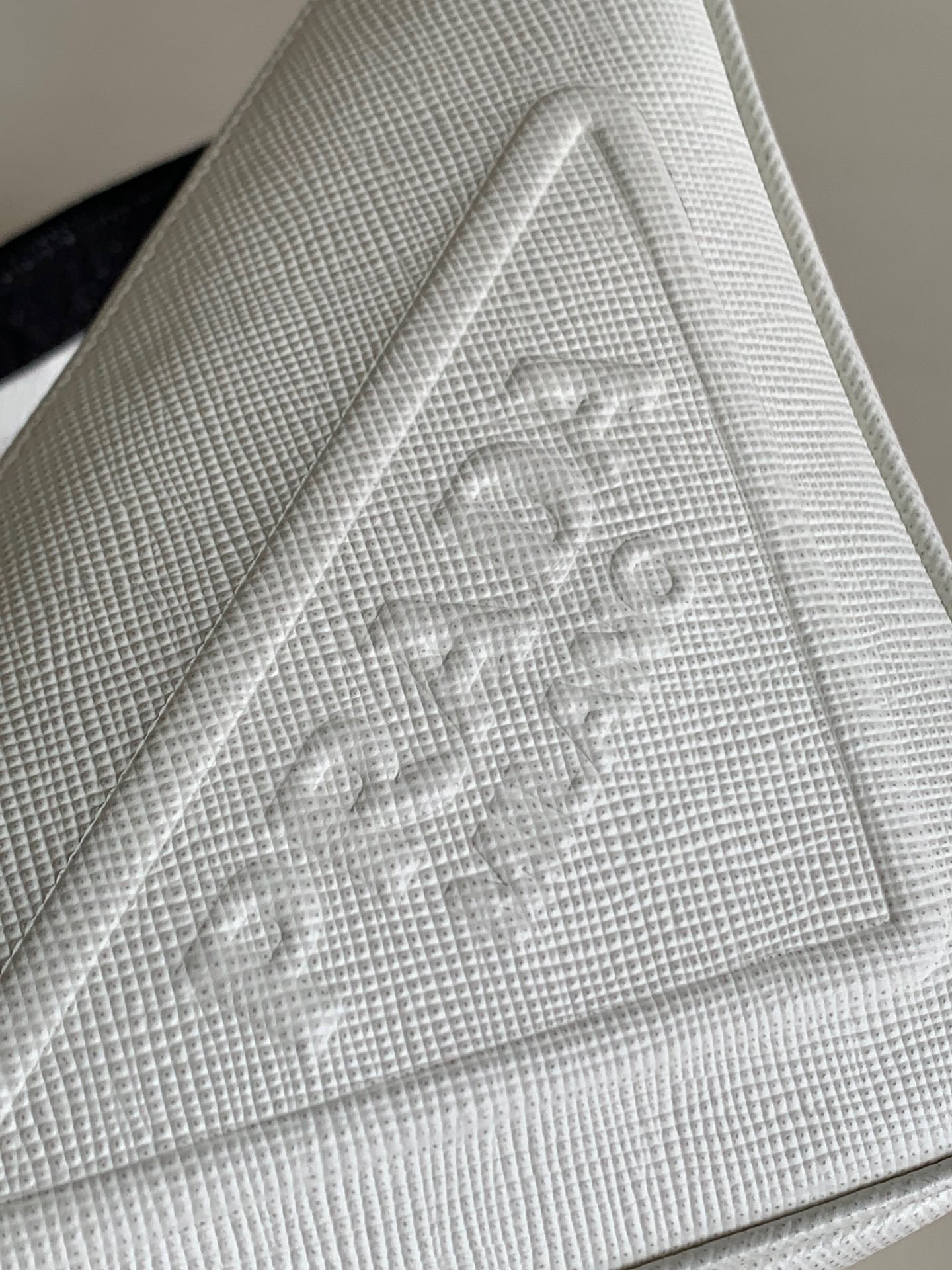 Pra*a triangle shoulder bag in white saffiano calfskin