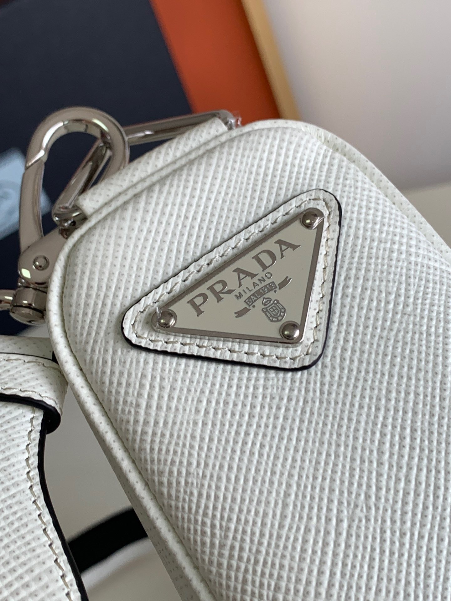 Pra*a triangle shoulder bag in white saffiano calfskin