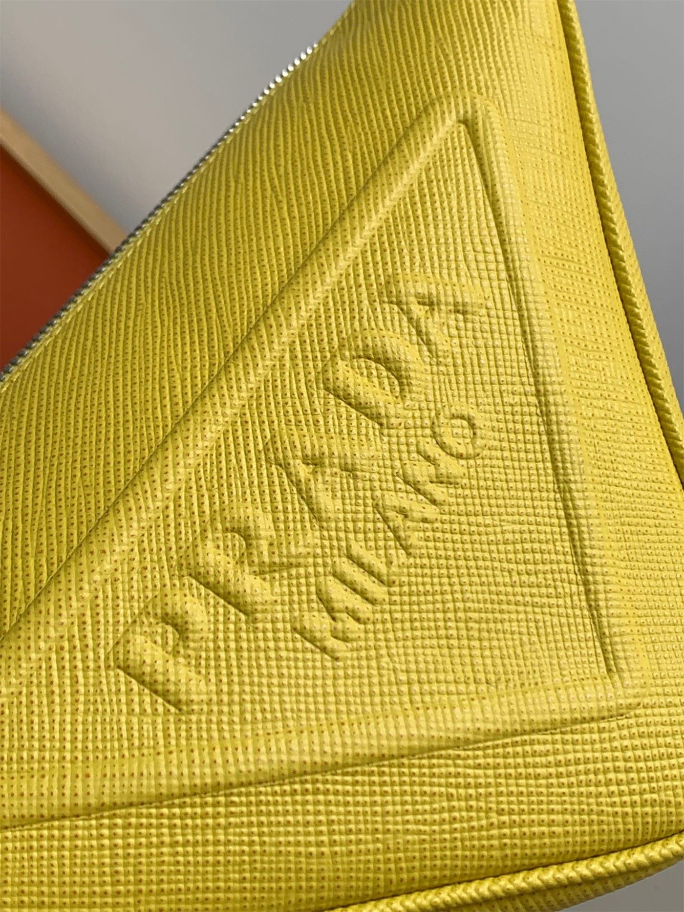 Pra*a triangle shoulder bag in yellow saffiano calfskin