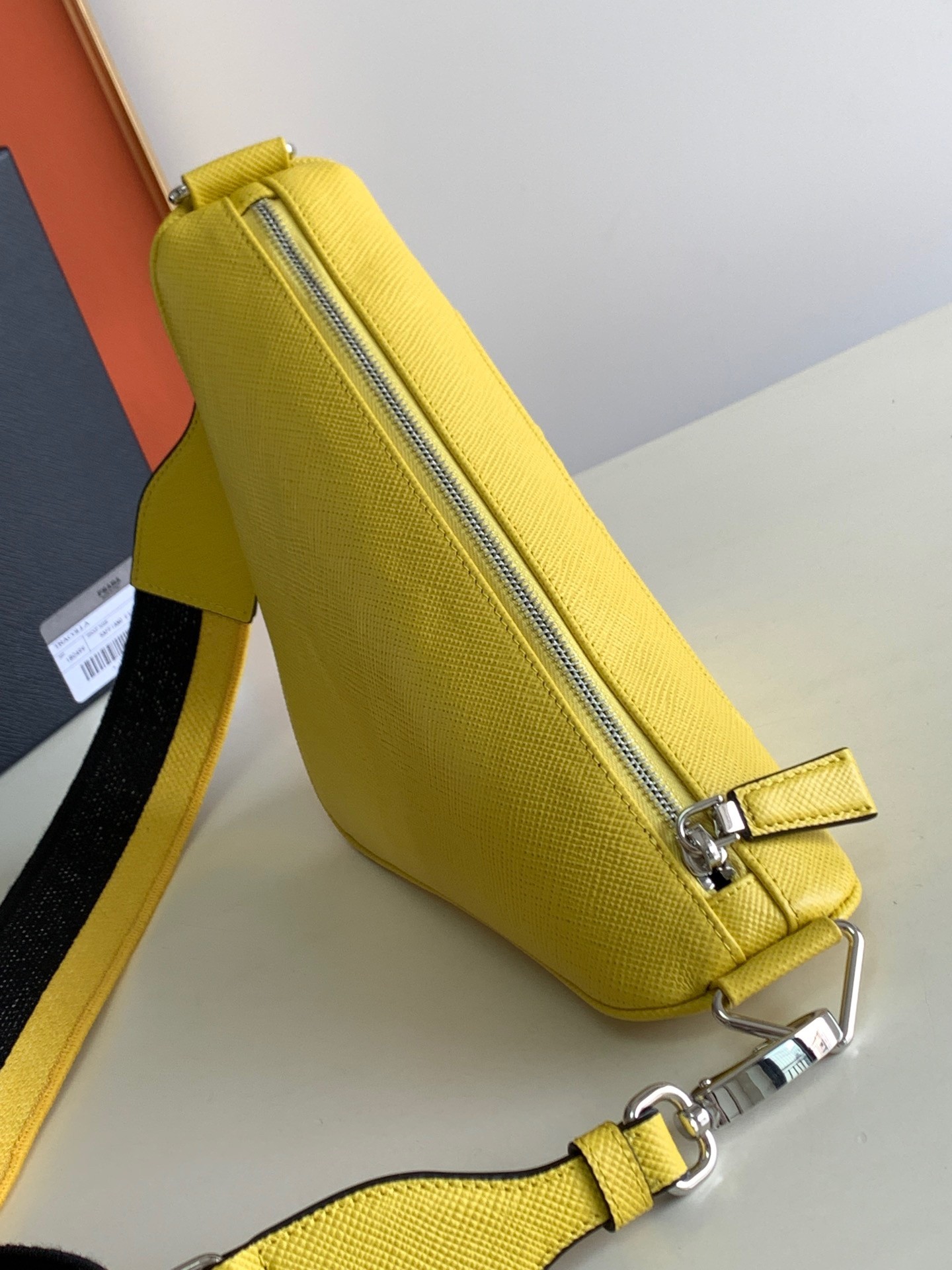 Pra*a triangle shoulder bag in yellow saffiano calfskin