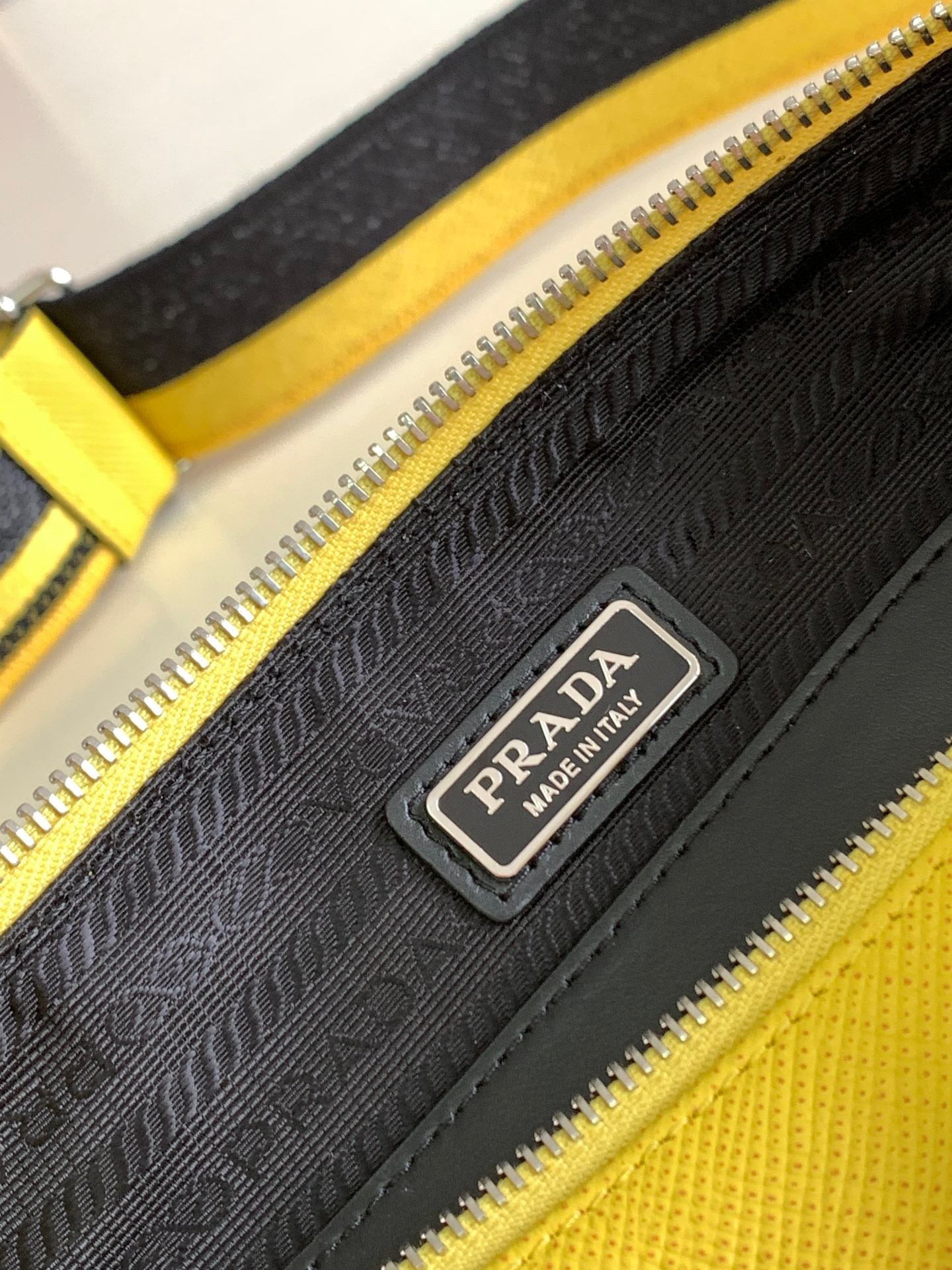 Pra*a triangle shoulder bag in yellow saffiano calfskin