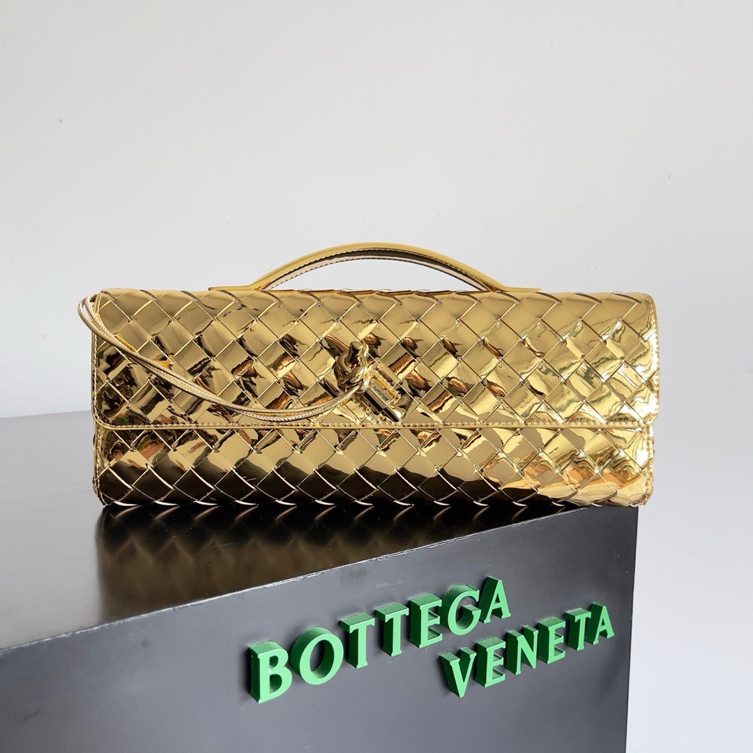 bo*te*ga Ve*ne*ta andiamo clutch with handle in gold metallic leather