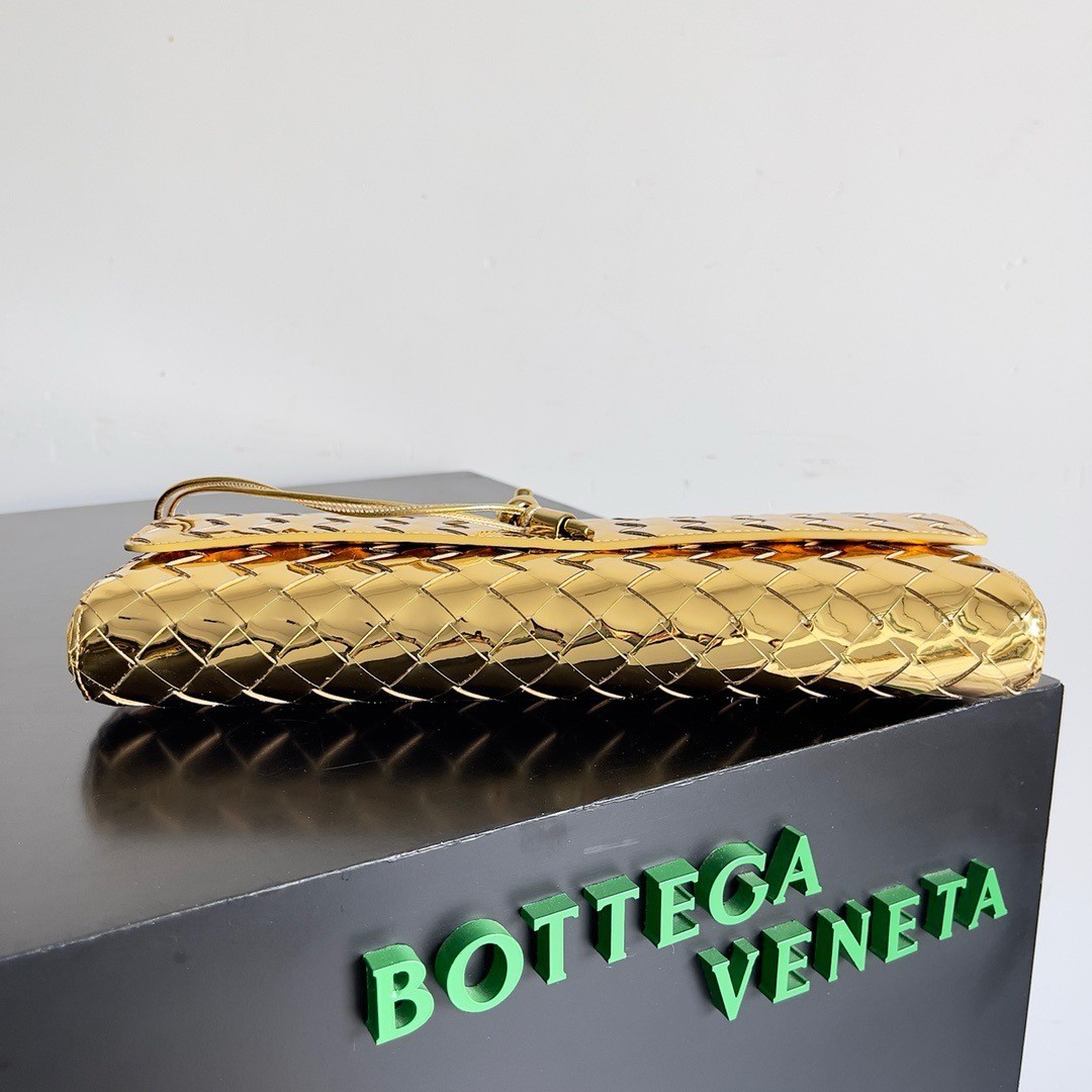 bo*te*ga Ve*ne*ta andiamo clutch with handle in gold metallic leather
