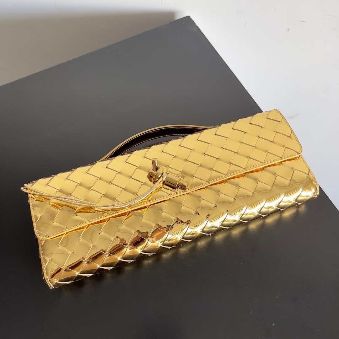 bo*te*ga Ve*ne*ta andiamo clutch with handle in gold metallic leather