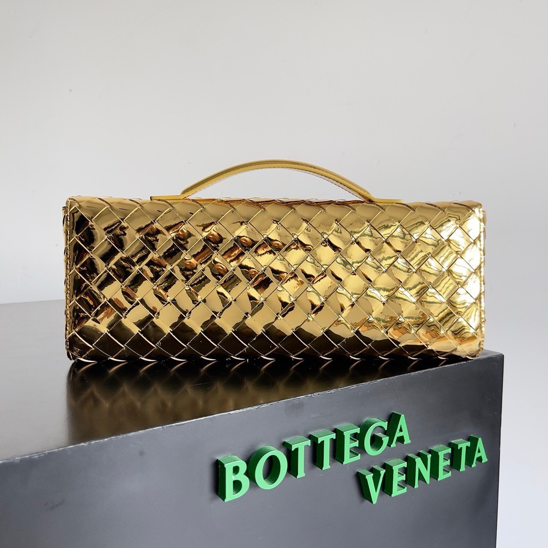 bo*te*ga Ve*ne*ta andiamo clutch with handle in gold metallic leather