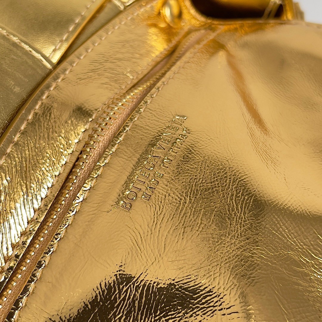bo*te*ga Ve*ne*ta small cassette bag in gold metallic lambskin