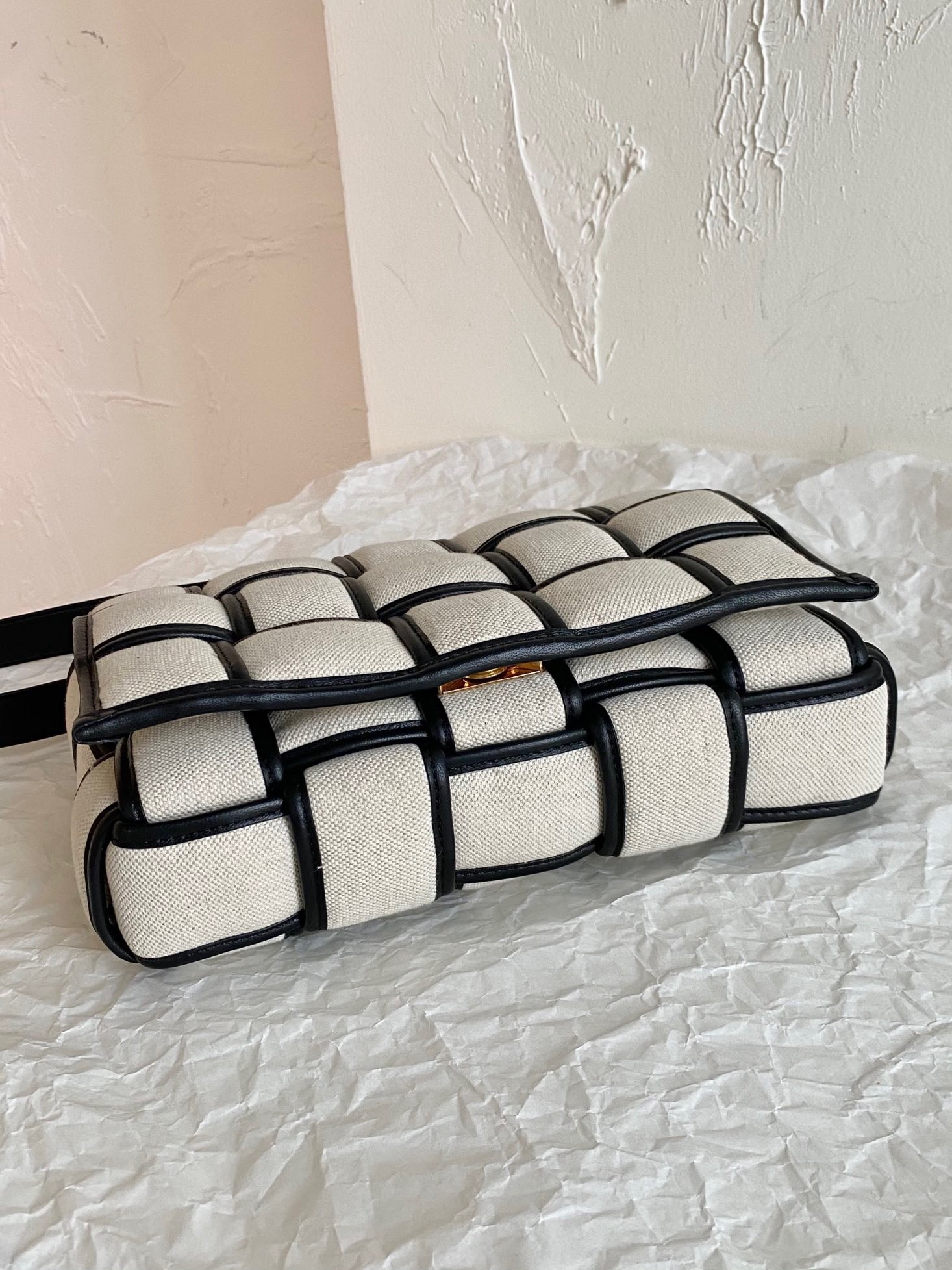 bo*te*ga Ve*ne*ta padded cassette bag in natural canvas