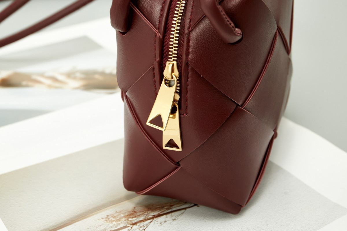 bo*te*ga Ve*ne*ta mini cassette camera bag in bordeaux lambskin