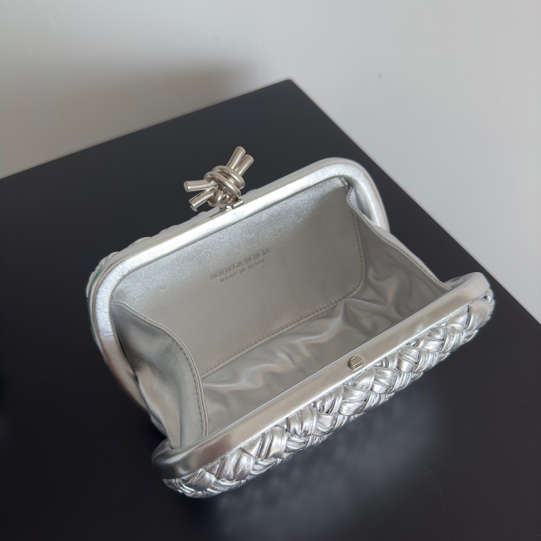 bo*te*ga Ve*ne*ta knot minaudiere clutch in silver intreccio laminated leather